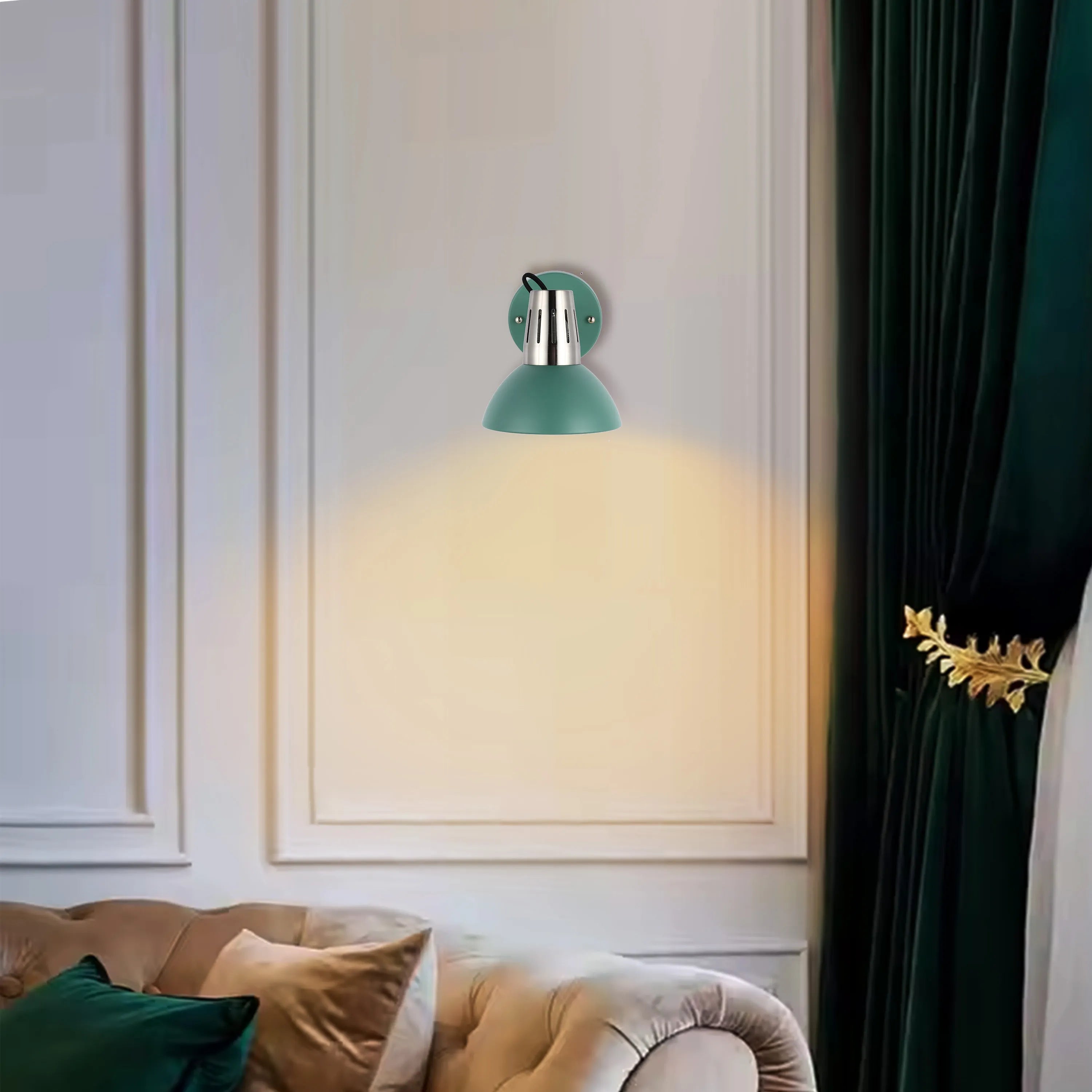 A green wall lamp with a silver fitting casts a warm glow, illuminating a beige wall and complementing the room's soft, elegant aesthetic.