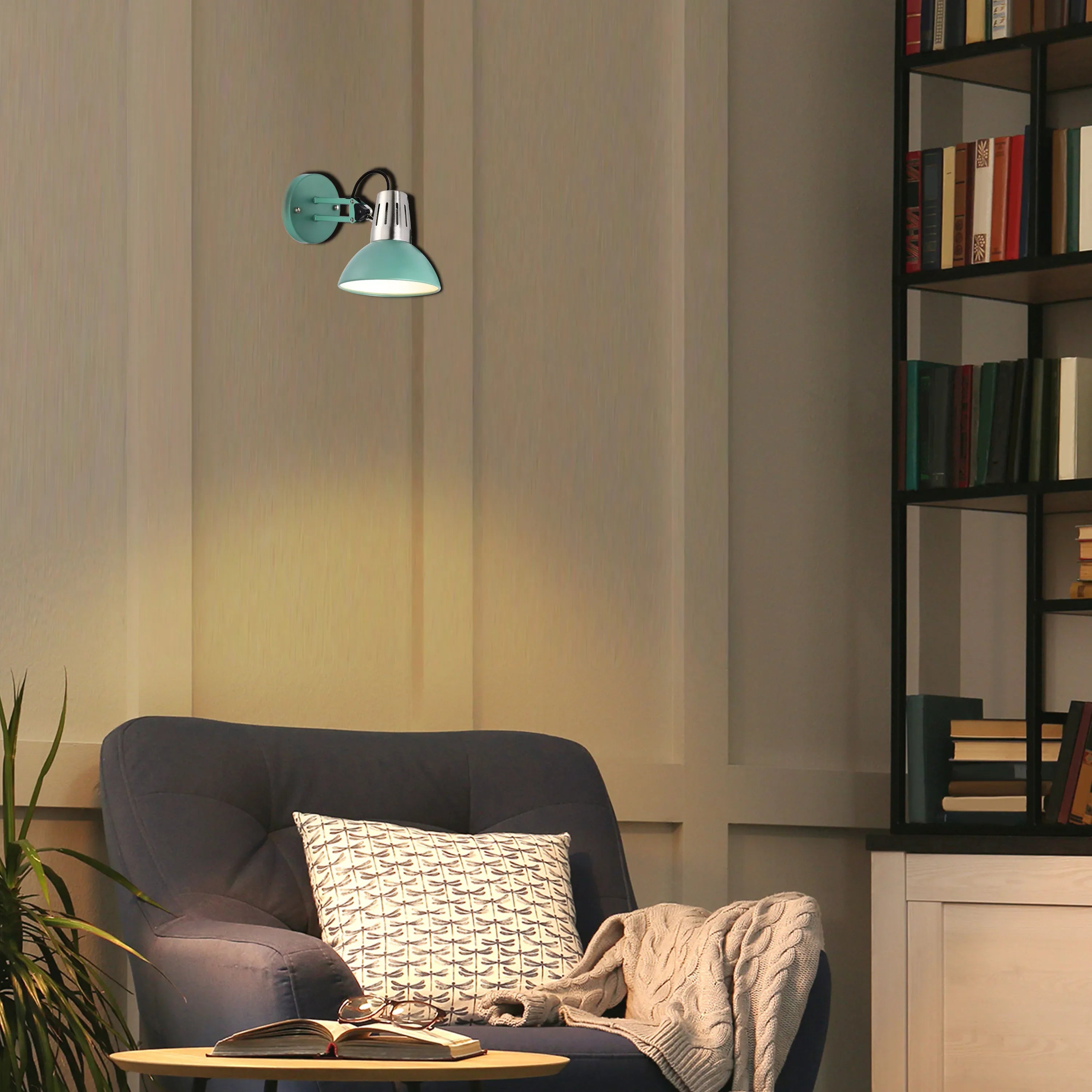 Stylish wall lamp provides a warm, inviting glow, complementing the cosy armchair and bookshelf in a relaxing reading nook.