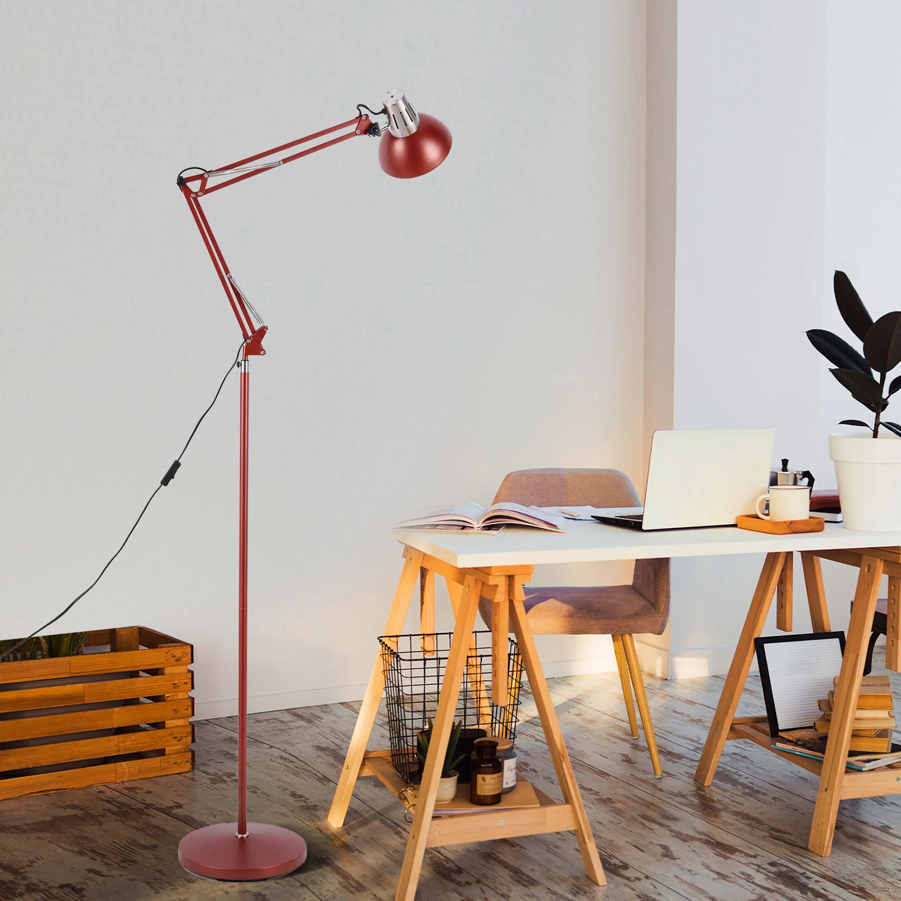 A red adjustable floor lamp illuminates a bright home office space, showcasing modern and practical lighting.