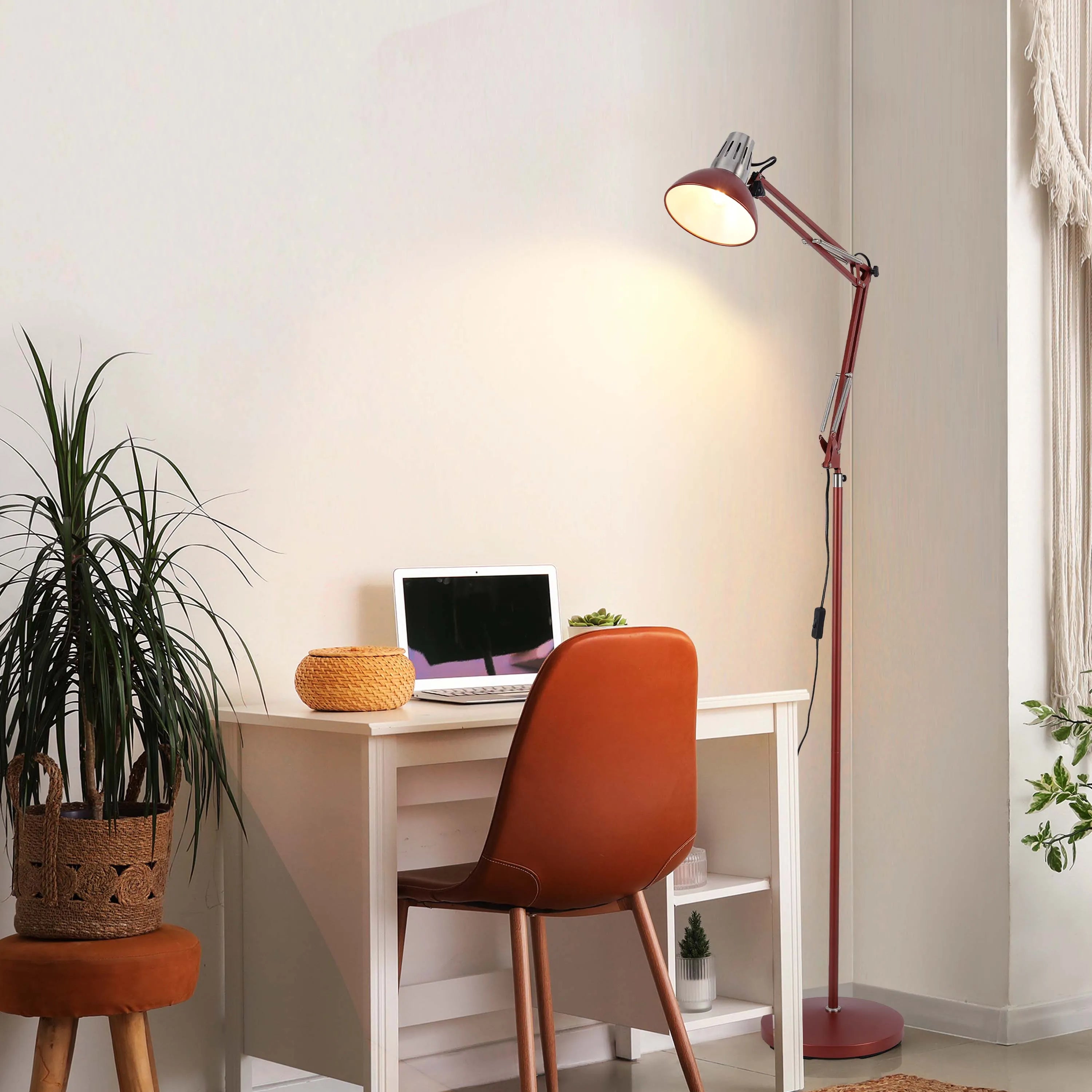 Angle-poise floor lamp providing task lighting over a desk in a home office.