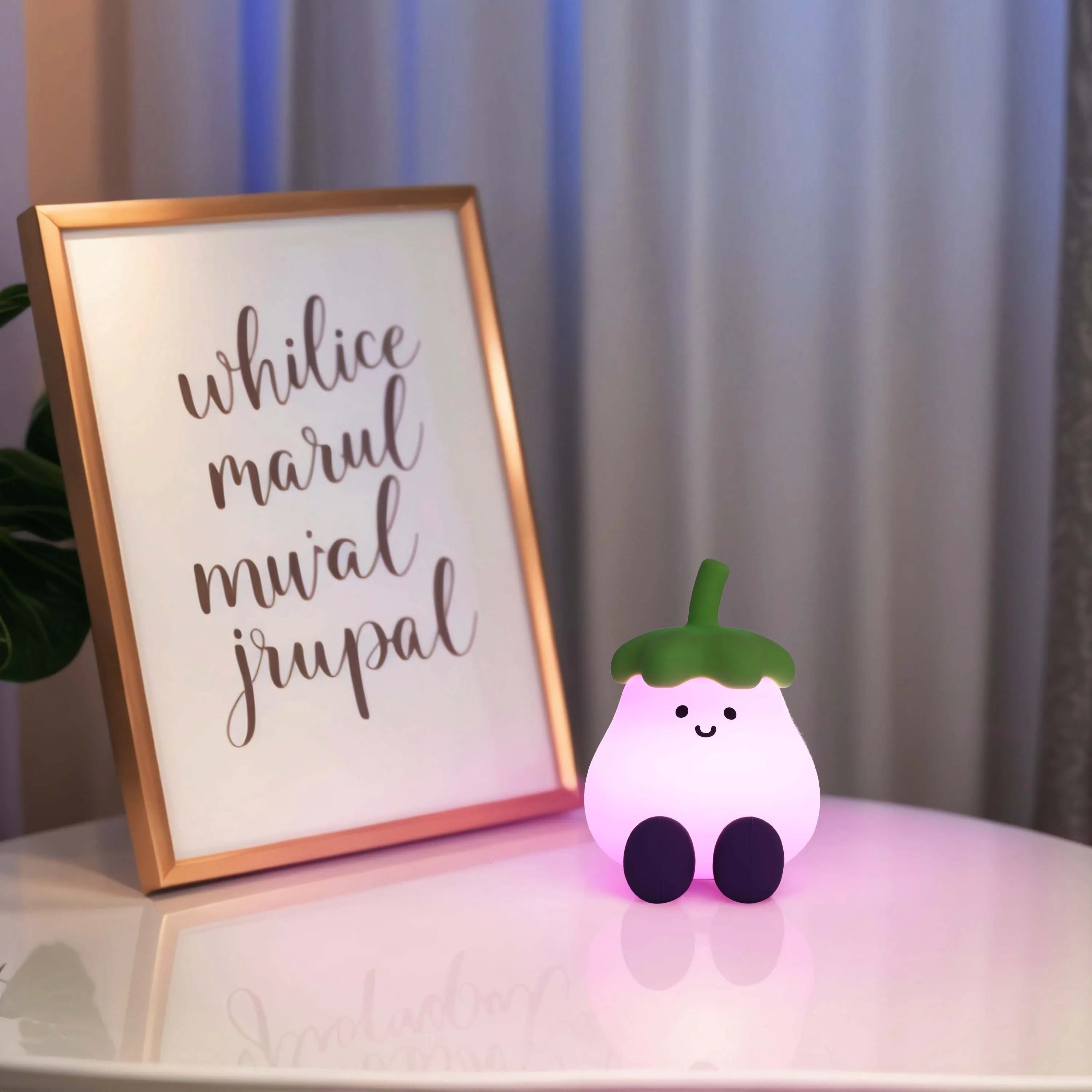 A cute eggplant-shaped night light emits a soft pink glow on a bedside table, creating a cosy and comforting atmosphere.