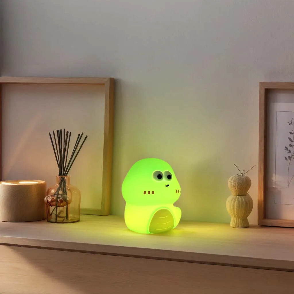 A vibrant green, cartoon dinosaur-shaped night light emits a soft glow. It is surrounded by soft, ambient light.