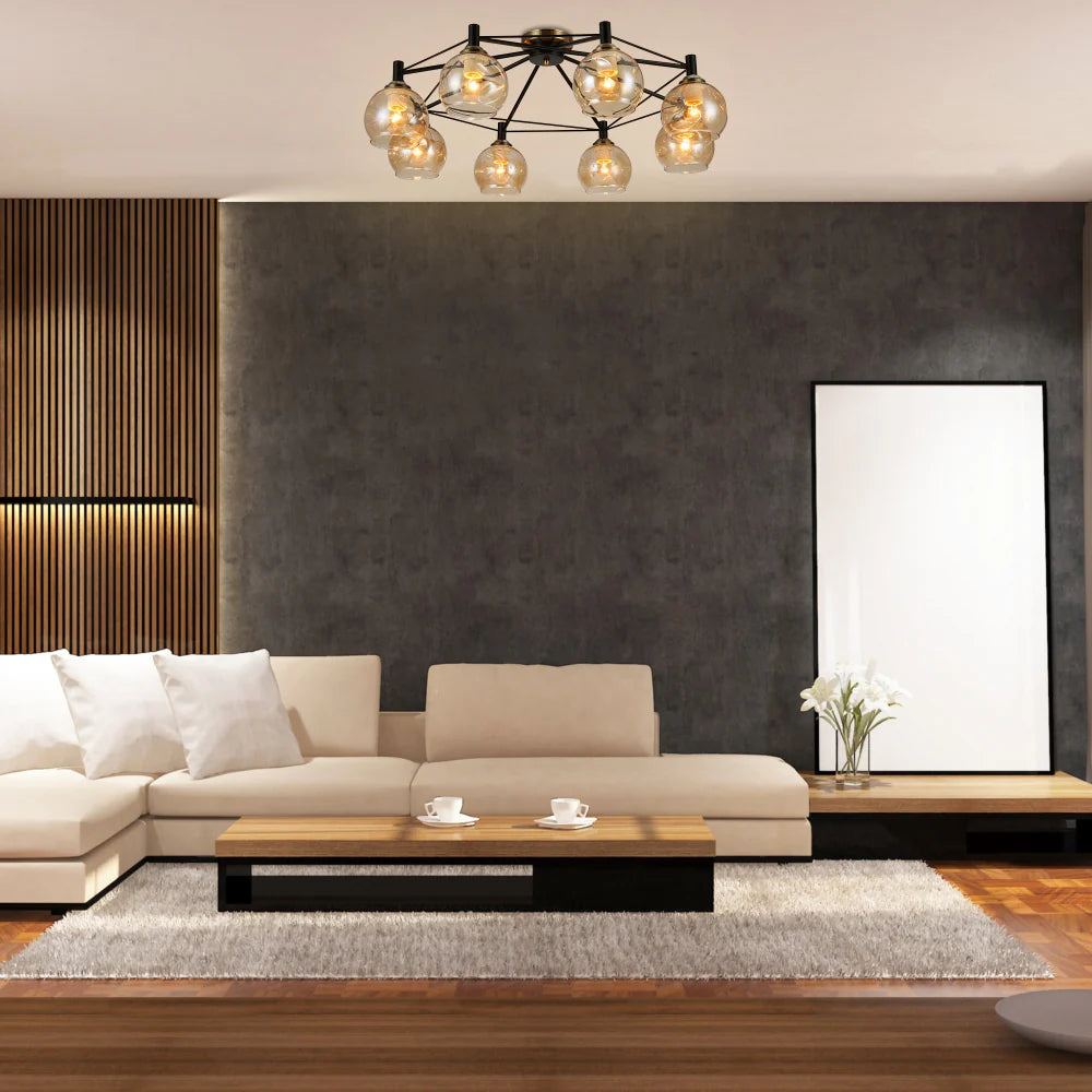 Contemporary chandelier with black framework and amber glass orbs, creating a warm and stylish ambience in the room.