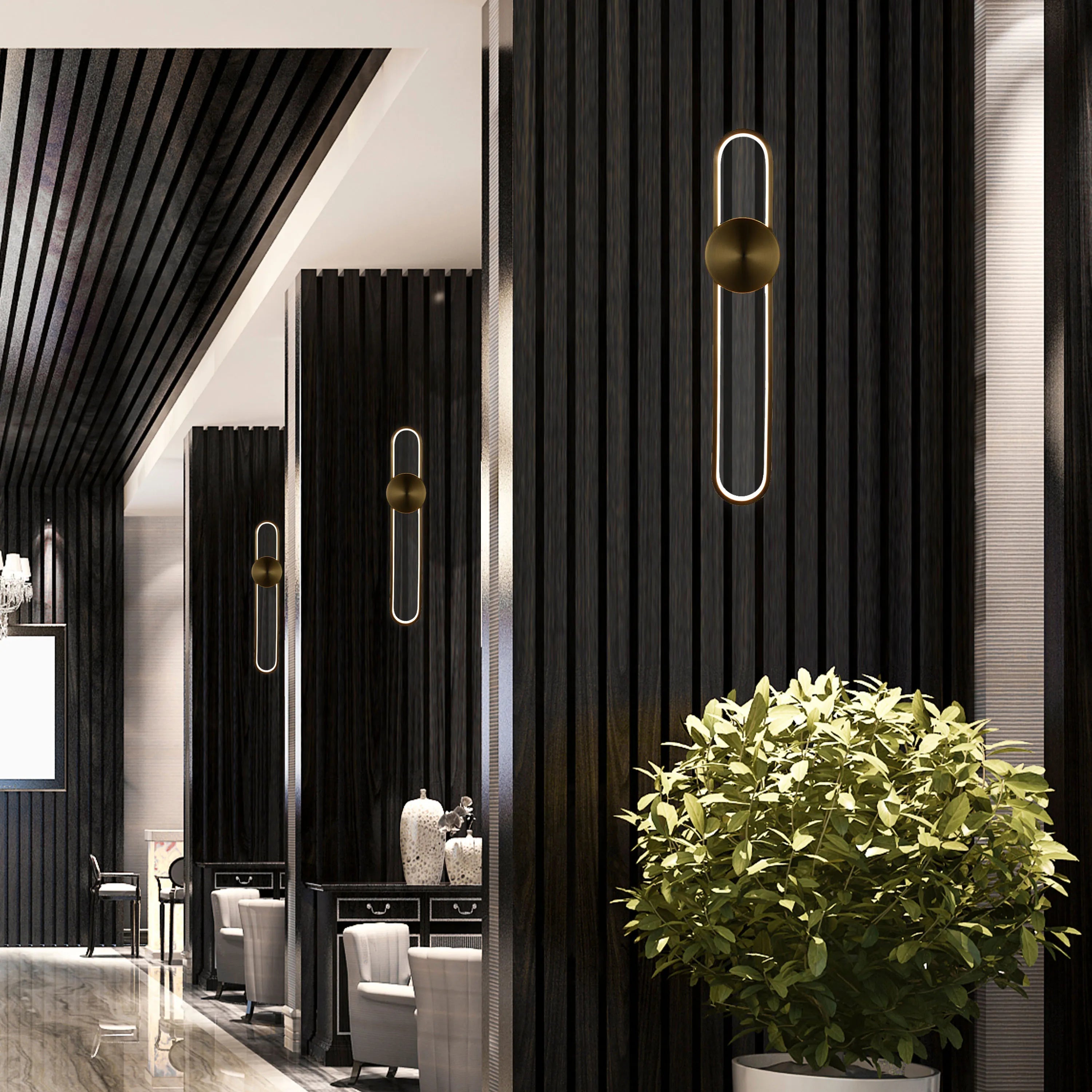 Stylish lighting featuring modern wall sconces with rounded, gold accents against a dark, wood-panelled wall.