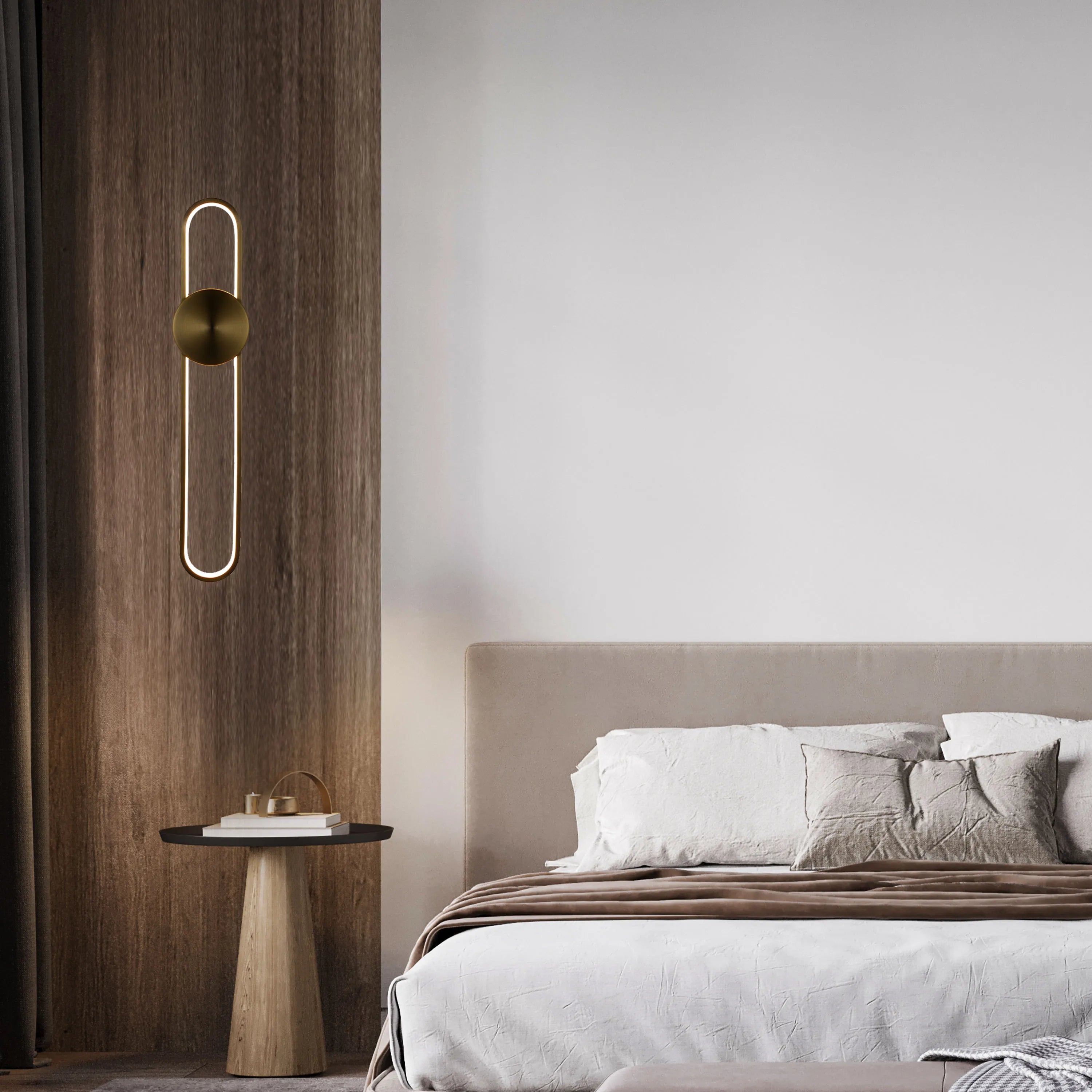Elegant wall lighting: A gold, capsule-shaped light fixture illuminates a modern bedroom setting with warm, ambient light.