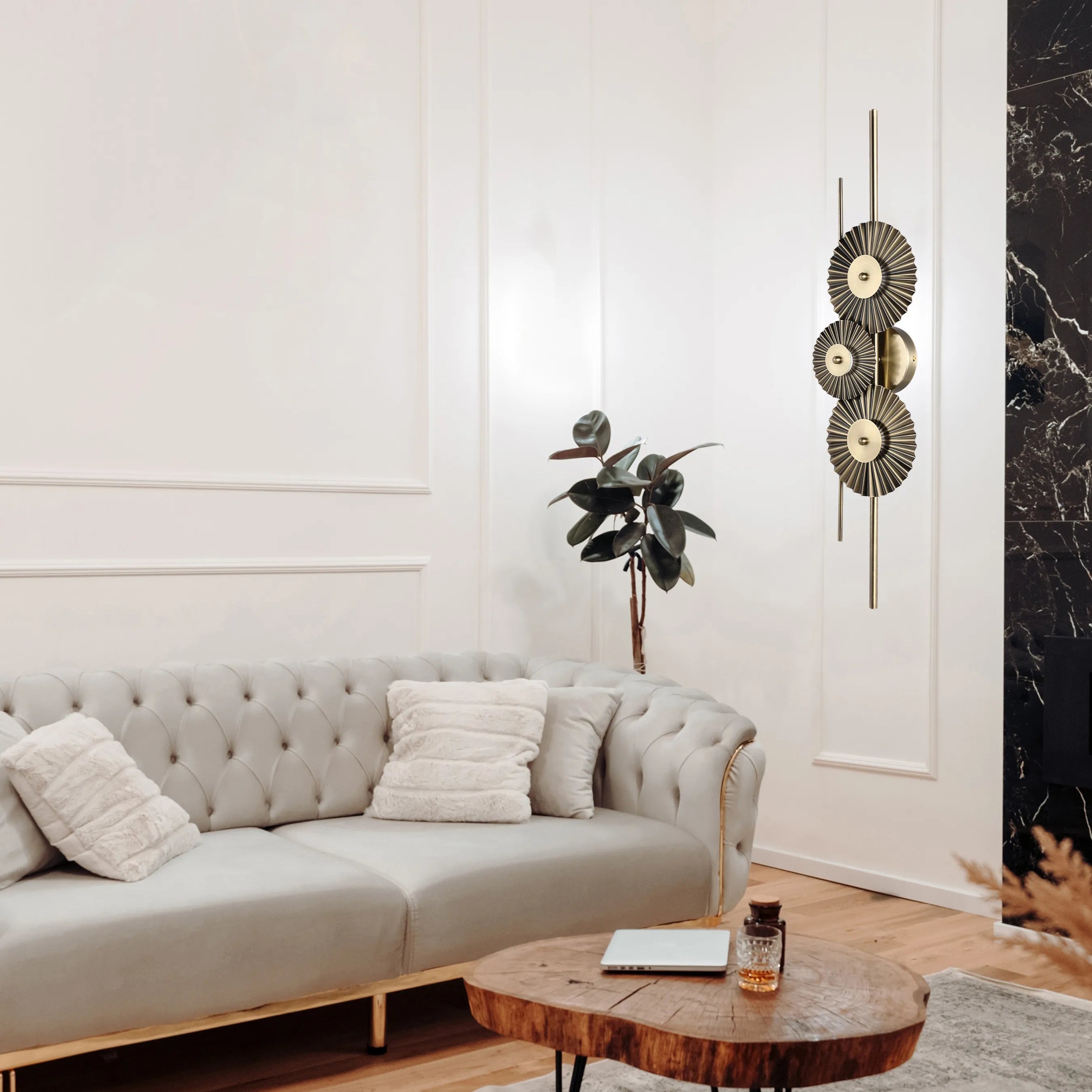 A decorative, three-tiered gold wall light illuminates the room, adding a touch of sophistication to the interior design.