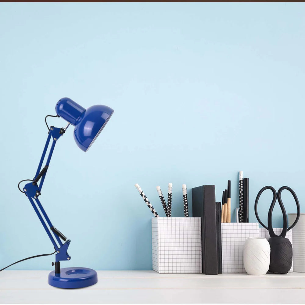 A tidy desk featuring a blue adjustable lamp, stationery holders, and assorted writing implements.