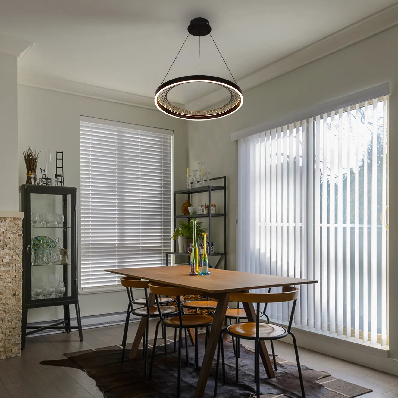 A modern circular LED pendant light illuminates a dining area with wood table and chairs, adding a stylish focal point.