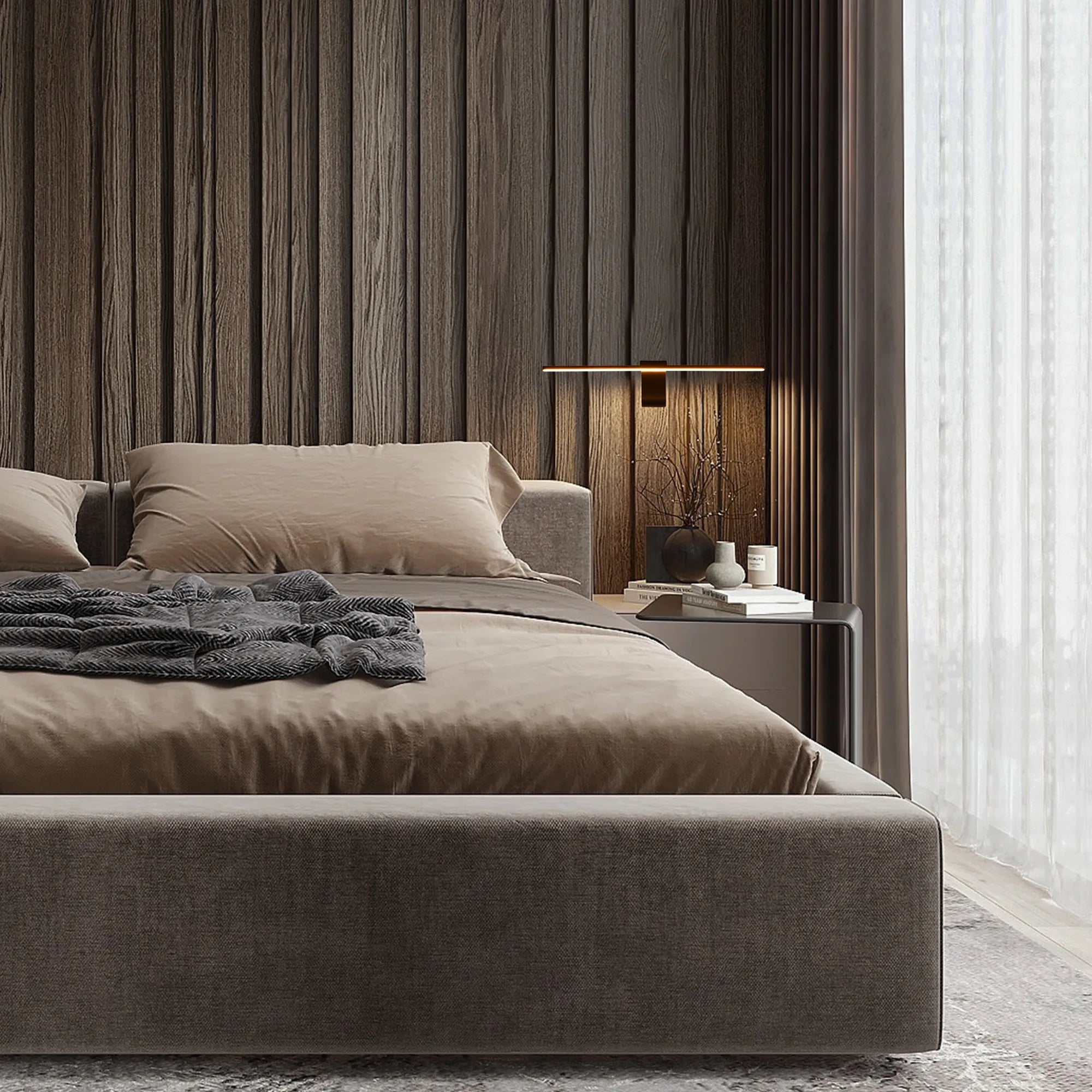 Subtle integrated lighting creates a warm, inviting ambience in this modern bedroom setting. Minimalist sconce adds to the understated elegance.