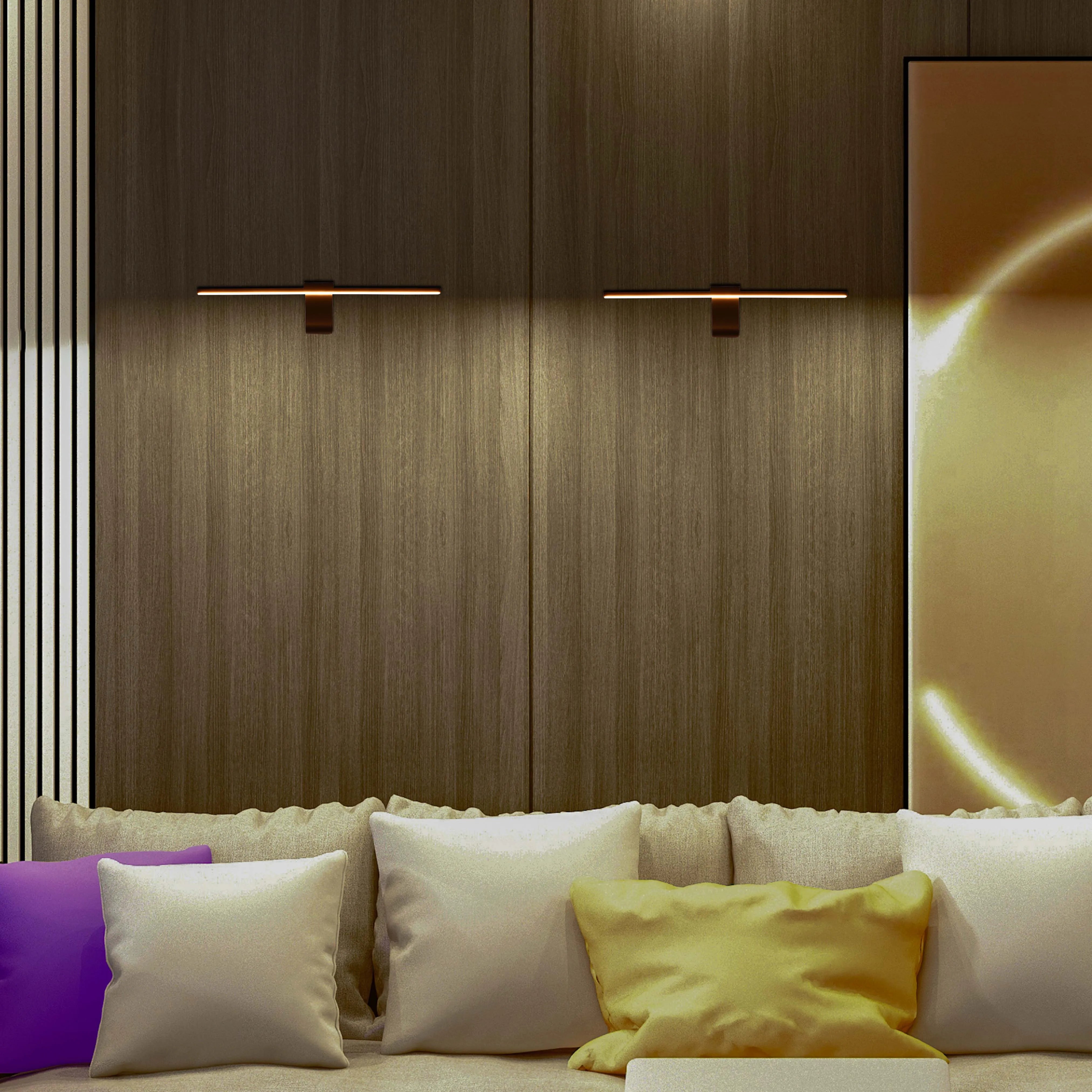 Modern wall lights illuminate a textured wall panel above a sofa with colourful scatter cushions, creating a cosy, ambient atmosphere.