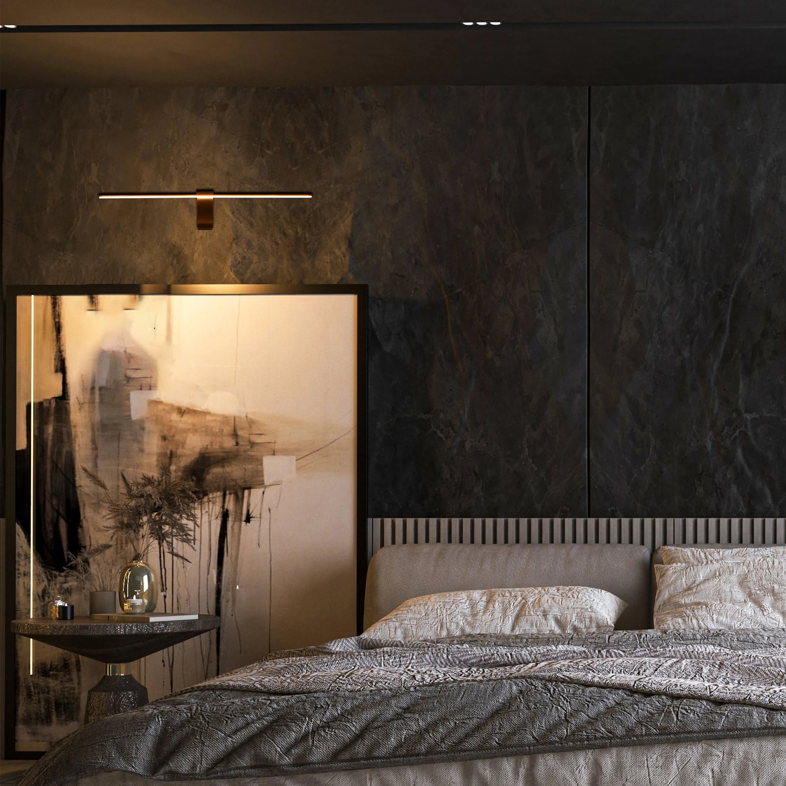 Stylish bedroom lighting: A linear wall light illuminates textured artwork above a bed, casting a warm glow in a sophisticated setting.