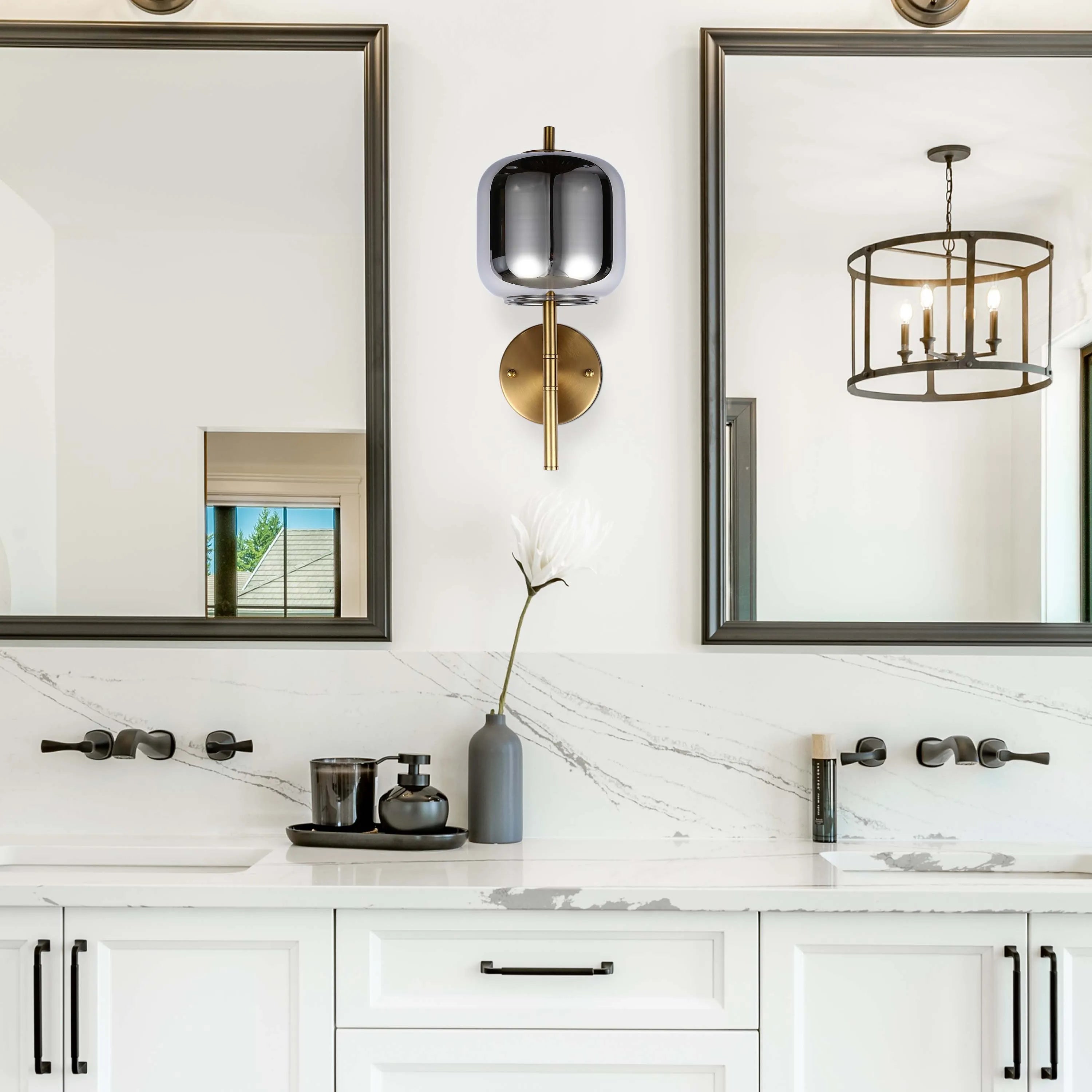 Bathroom vanity with wall lights and a pendant light reflected in the mirrors above the sinks.