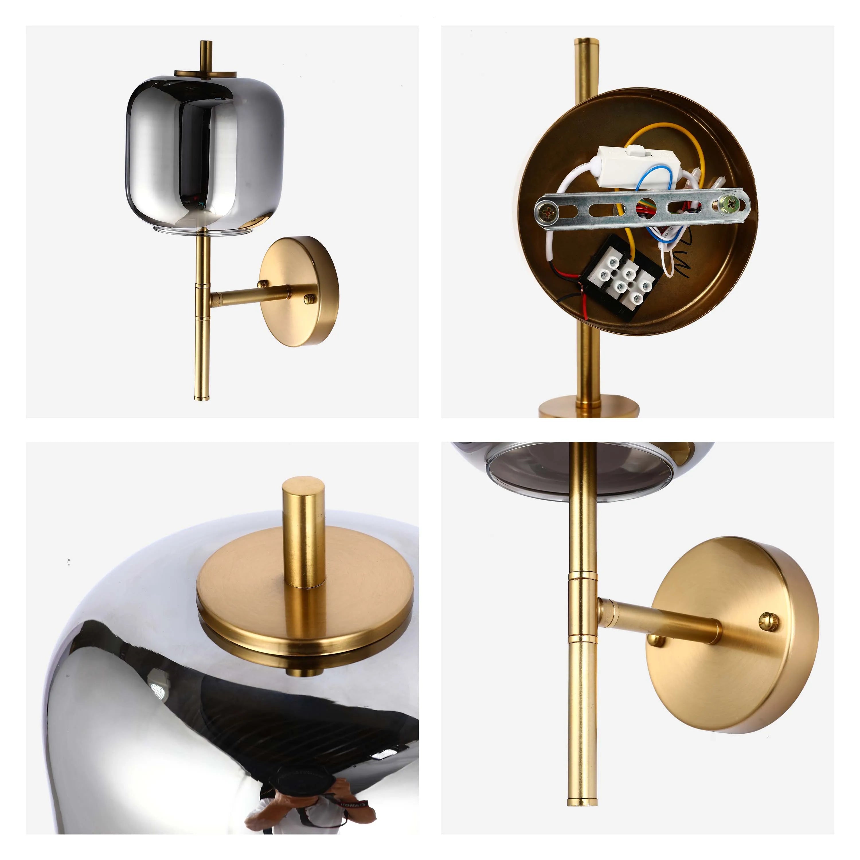 Modern wall light with a smoked glass shade and gold metal finish. Stylish and sophisticated lighting for any room.