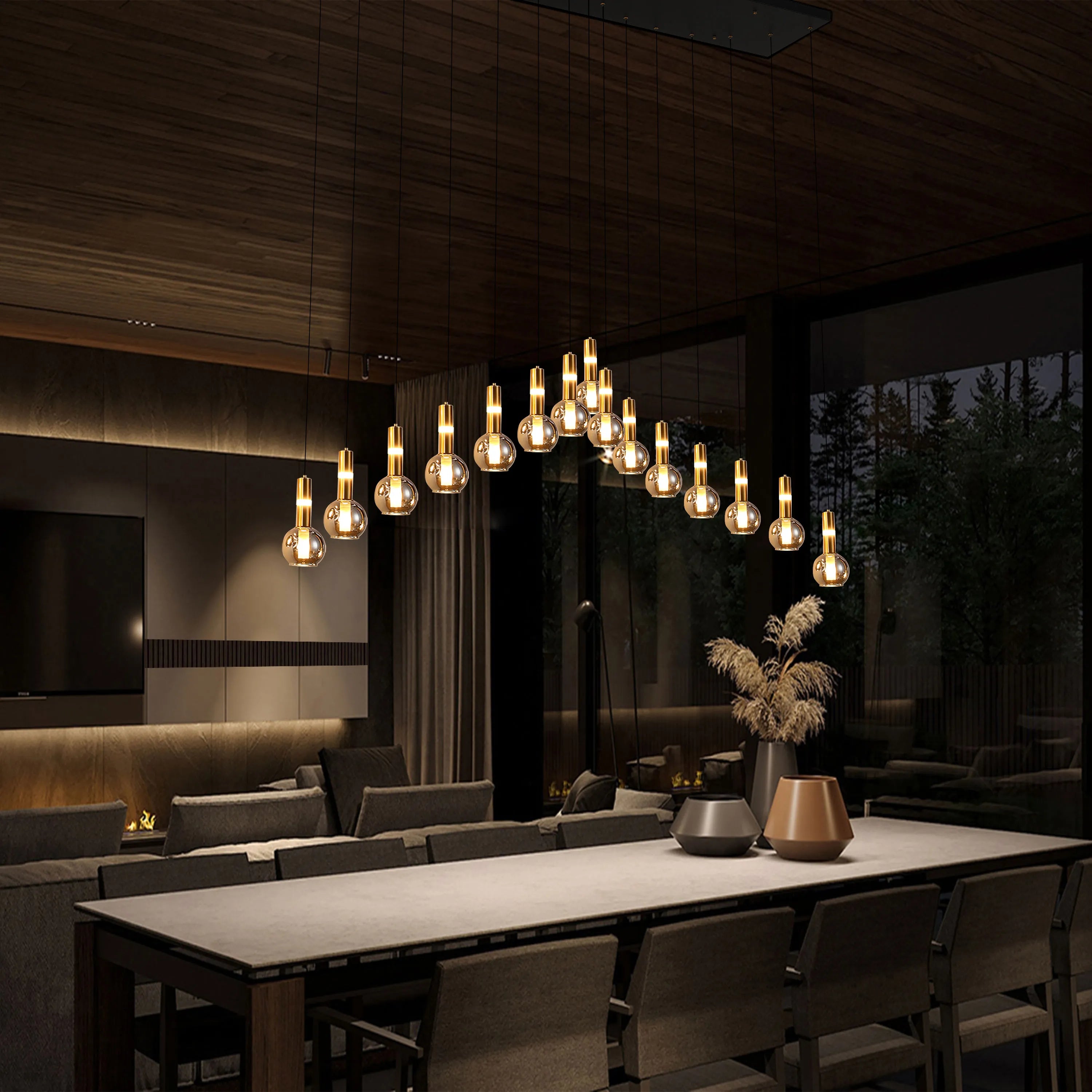 Contemporary pendant lighting with glass and gold accents, hanging above a dining table. Modern and luxurious interior design.