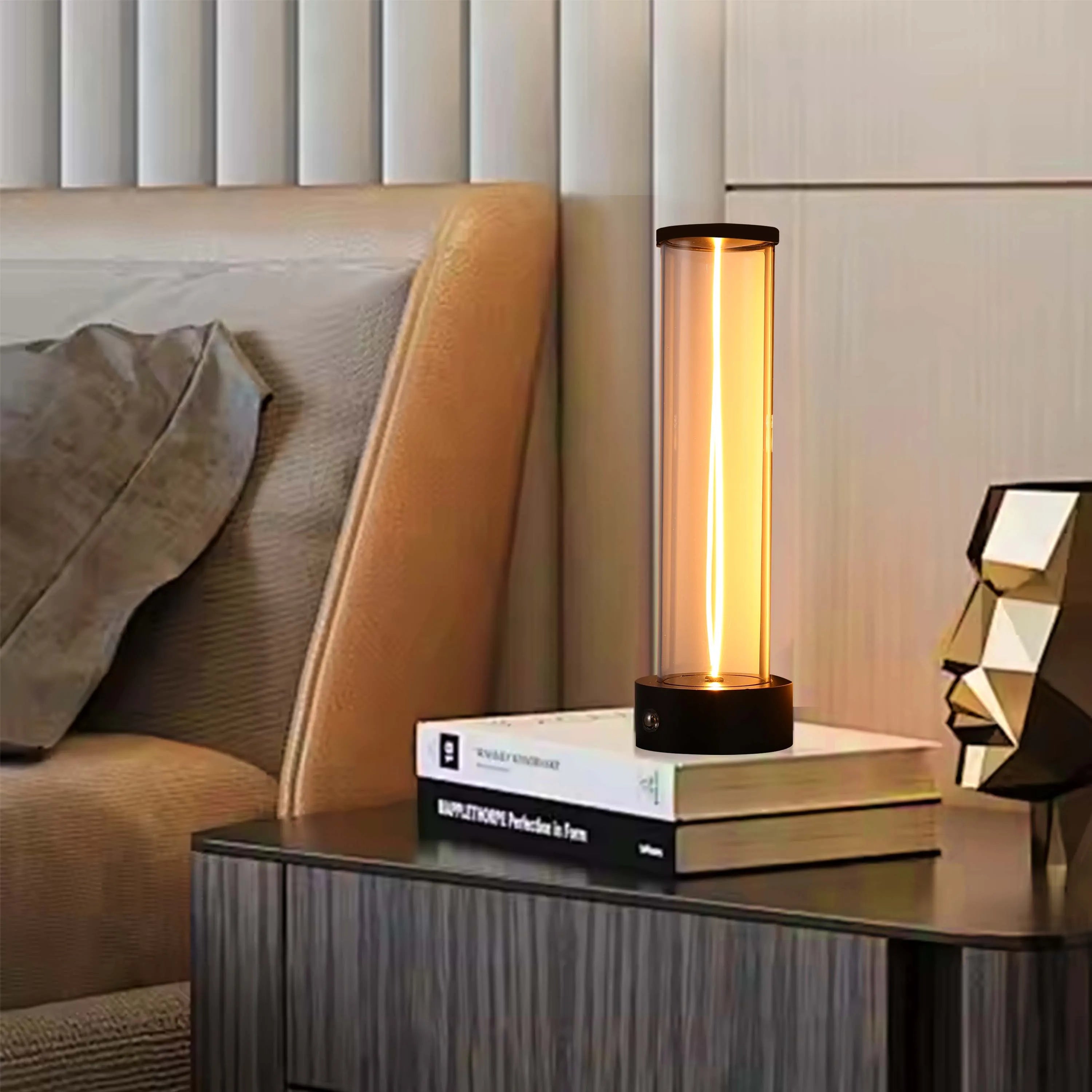 Modern bedside lamp with a glass tube, emitting a warm, ambient glow. Stylish lighting that adds a touch of elegance.
