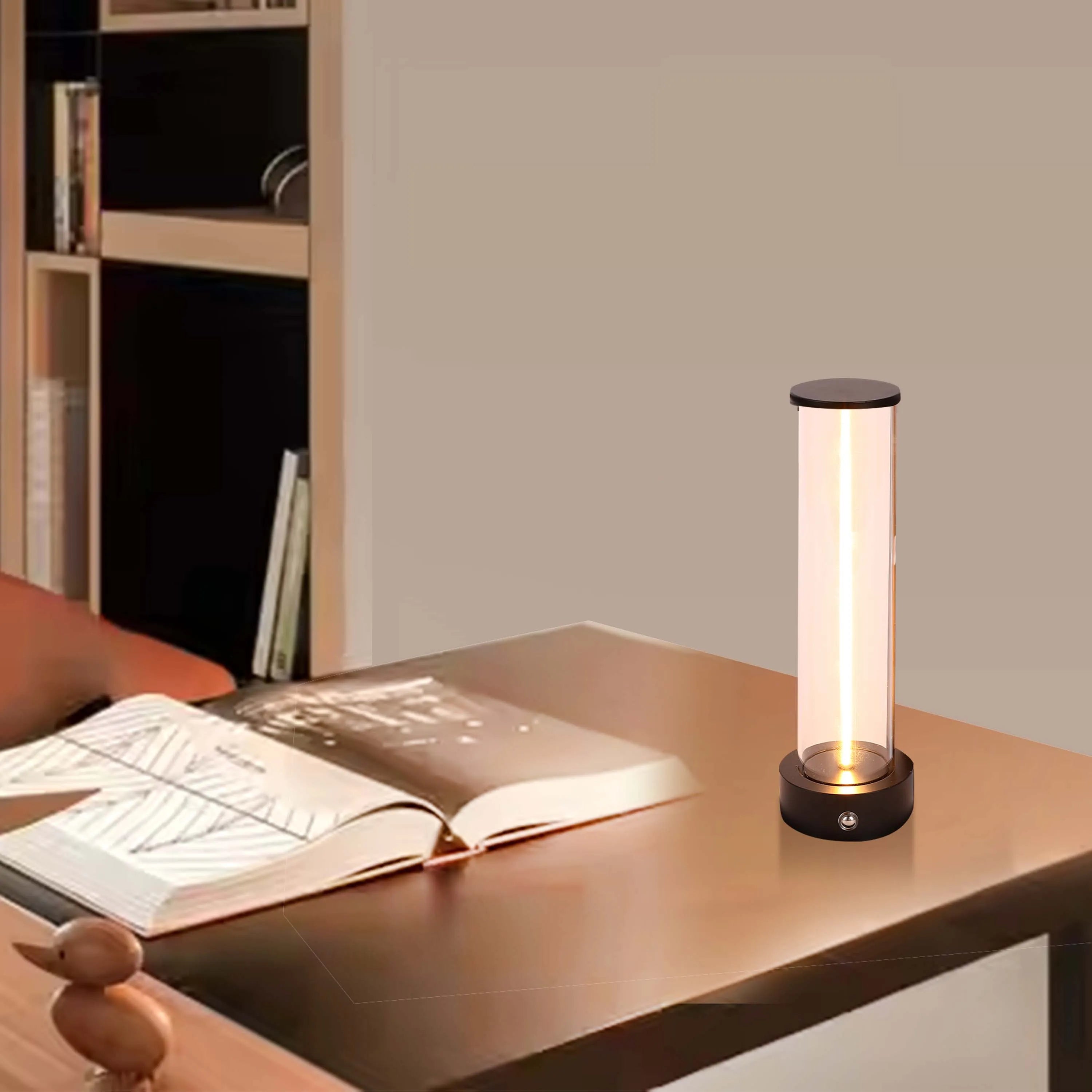 A sleek modern table lamp with a cylindrical glass shade and warm, inviting light. Ideal for a cosy reading nook or ambient lighting.