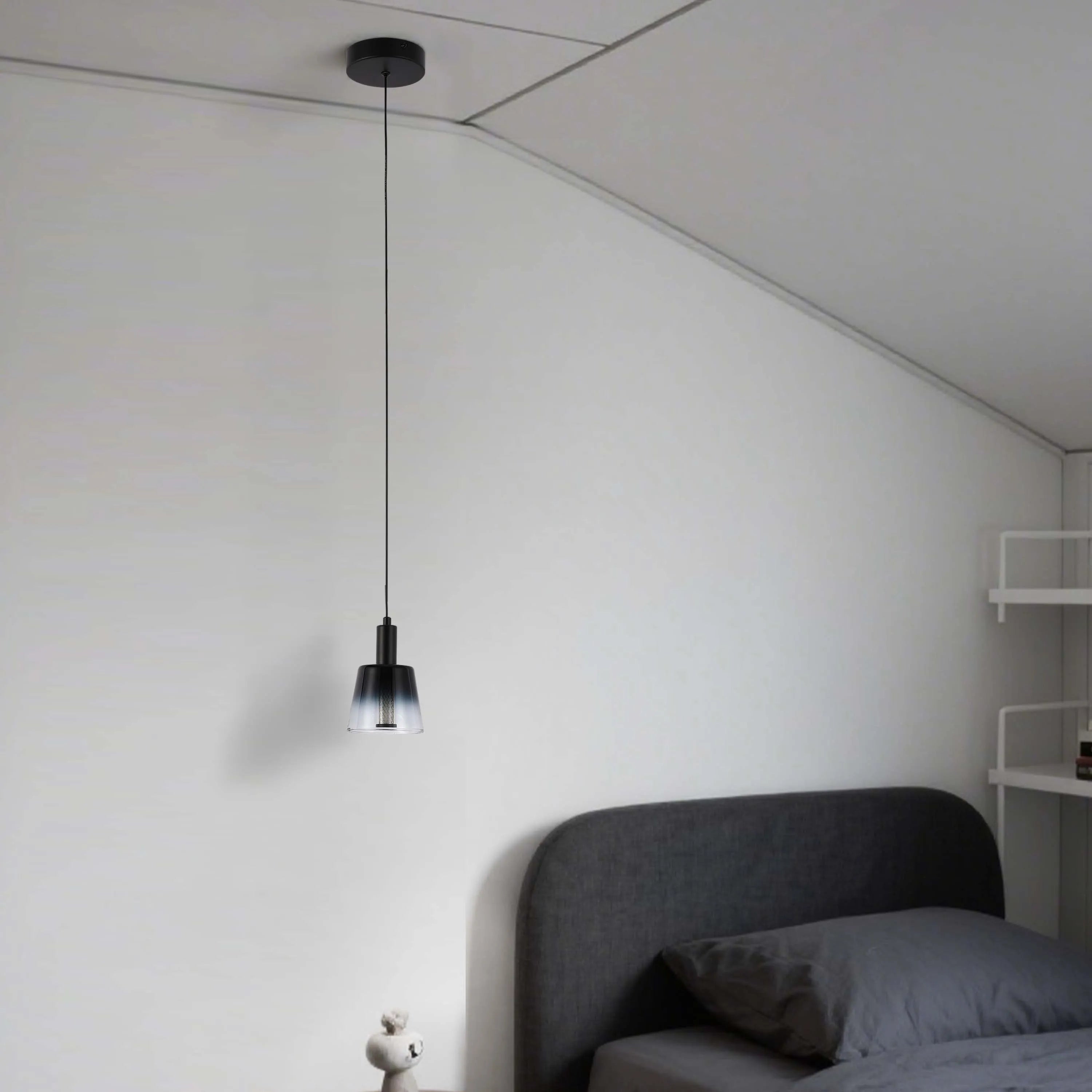 A modern, dimmable pendant light featuring a sleek black fixture and clear, ombre glass shade. Perfect for creating ambient lighting.