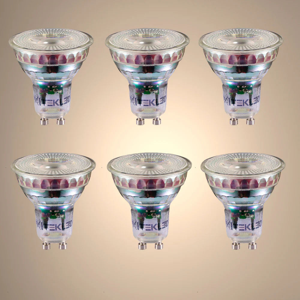Six Xitekle LEDs. The spotlights have a transparent front and silver bases, displayed on a warm background.