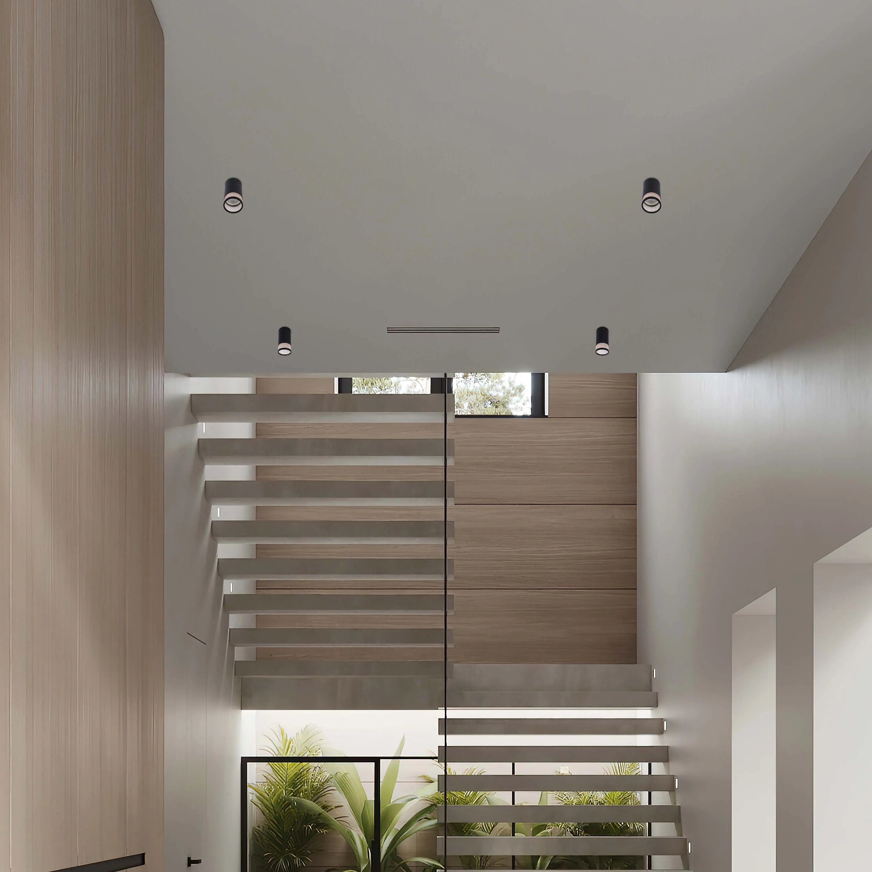 Contemporary interior showcasing recessed spotlights, casting a soft glow on the staircase and adjacent wooden panelling.