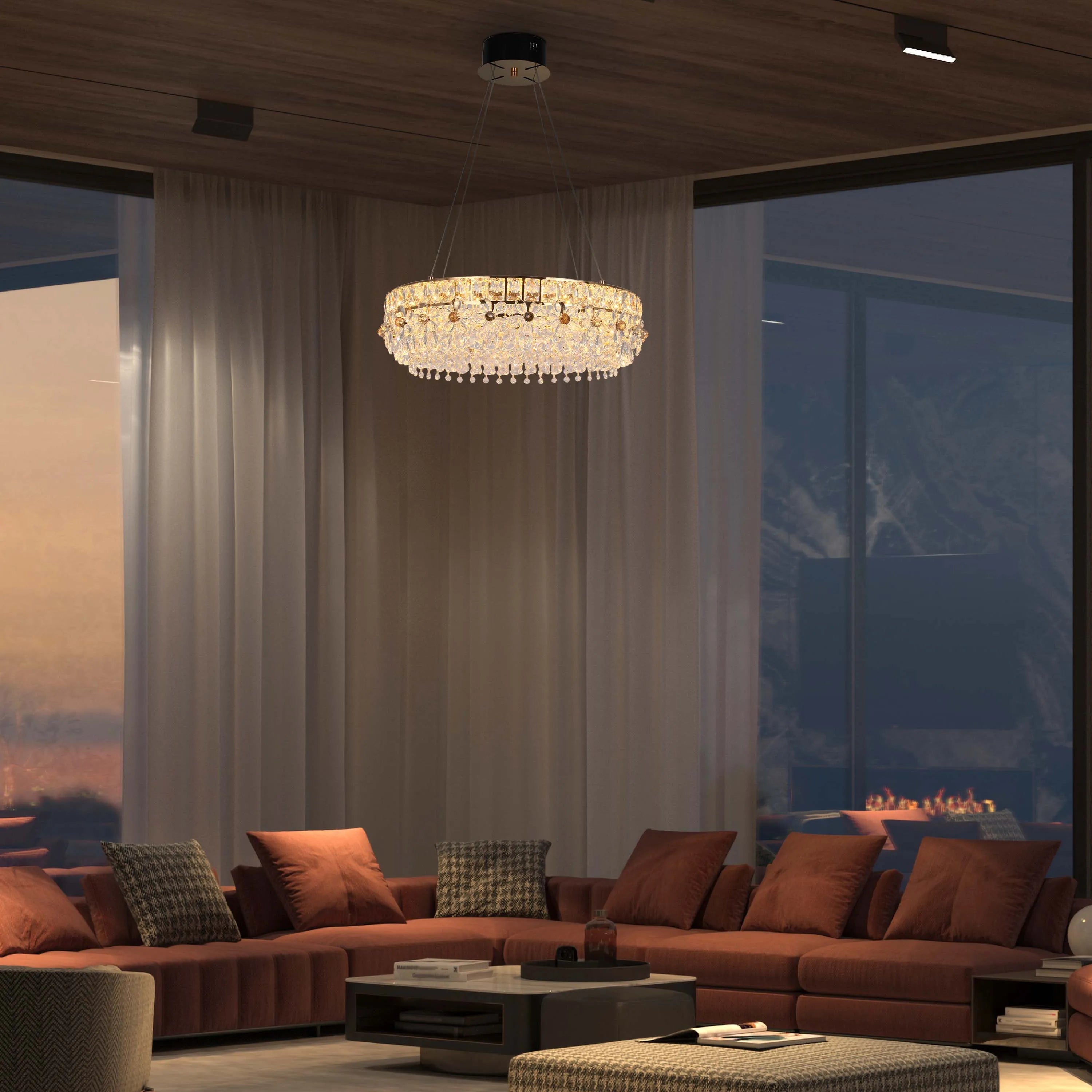 A modern living room showcases a dazzling crystal chandelier, complemented by sleek track lighting on the wooden ceiling.