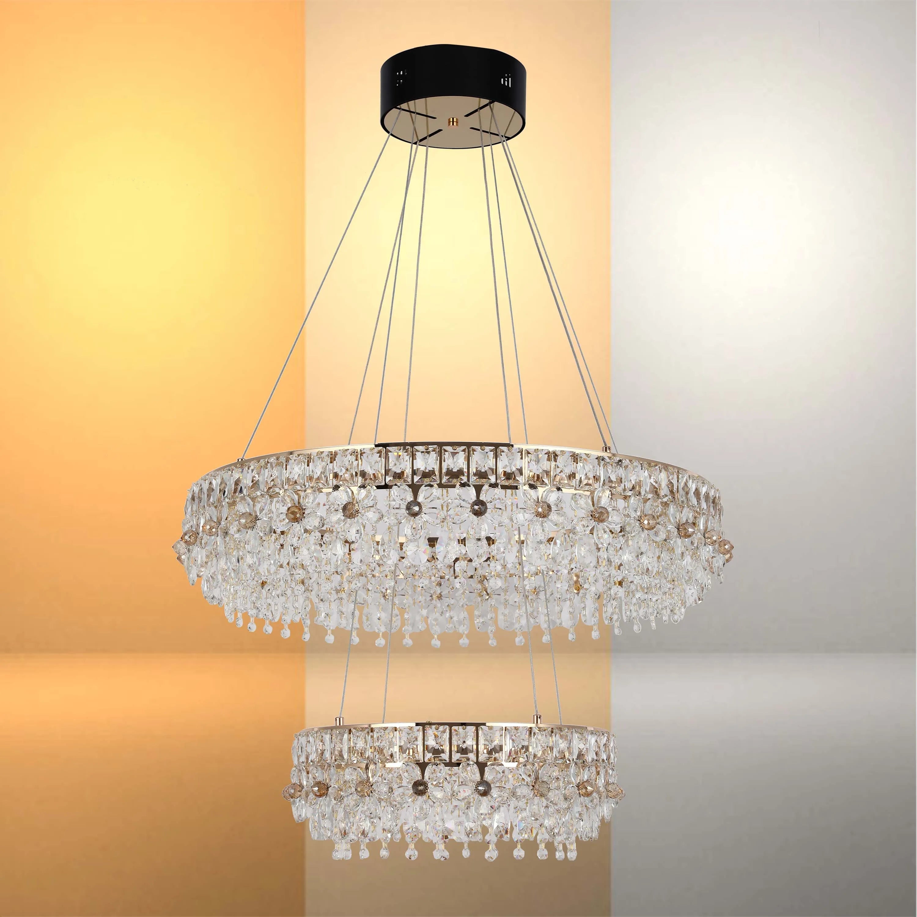 Two-tier chandelier with crystal accents, suspended from a round black ceiling fixture with supporting cables.