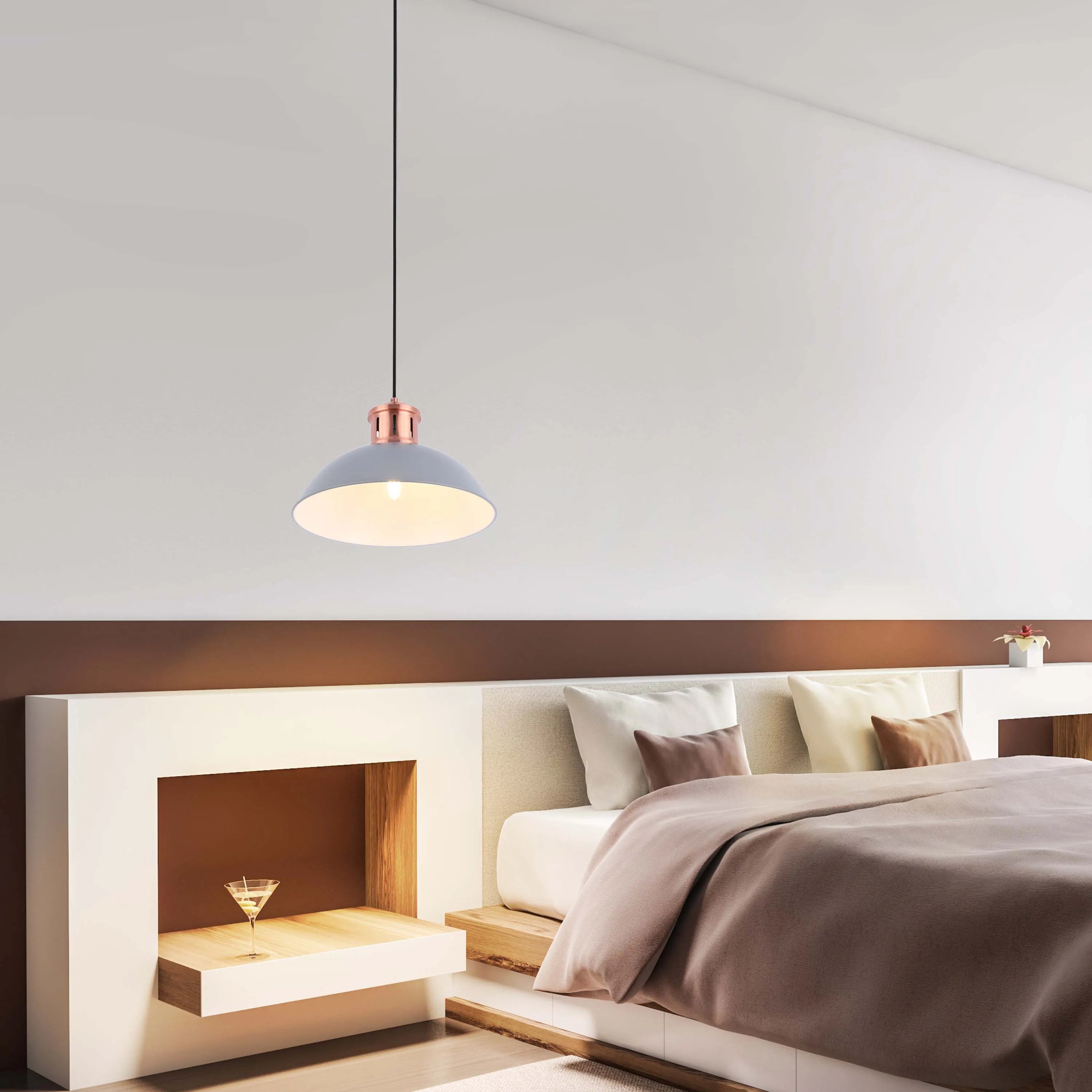 Bedroom with a grey and copper pendant light above the bedside table, illuminating the bed and cocktail.