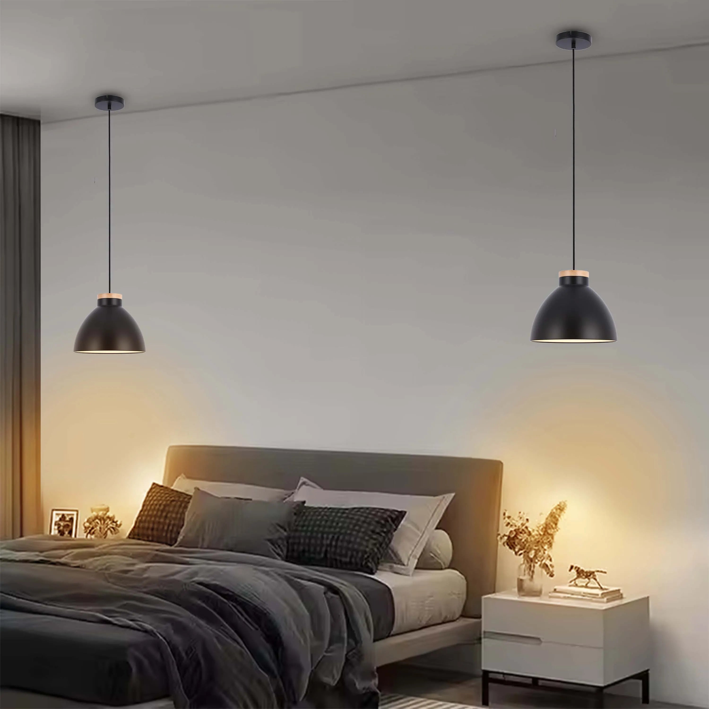 Stylish bedroom lighting. Two black pendant lights provide warm illumination on either side of the bed for a cosy ambience.