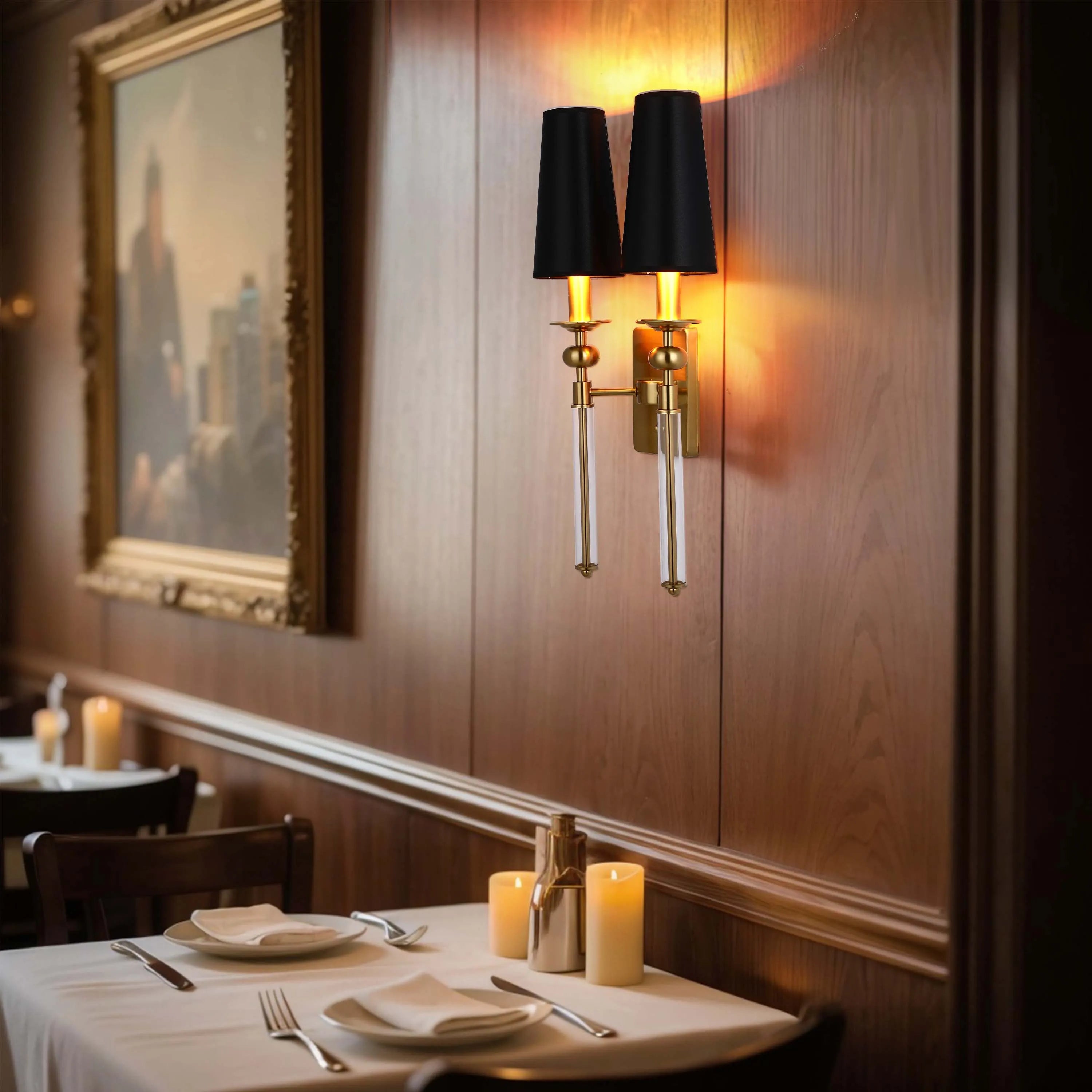 A warm, ambient lighting scheme in a restaurant, created with sconces, candles and artwork lighting.