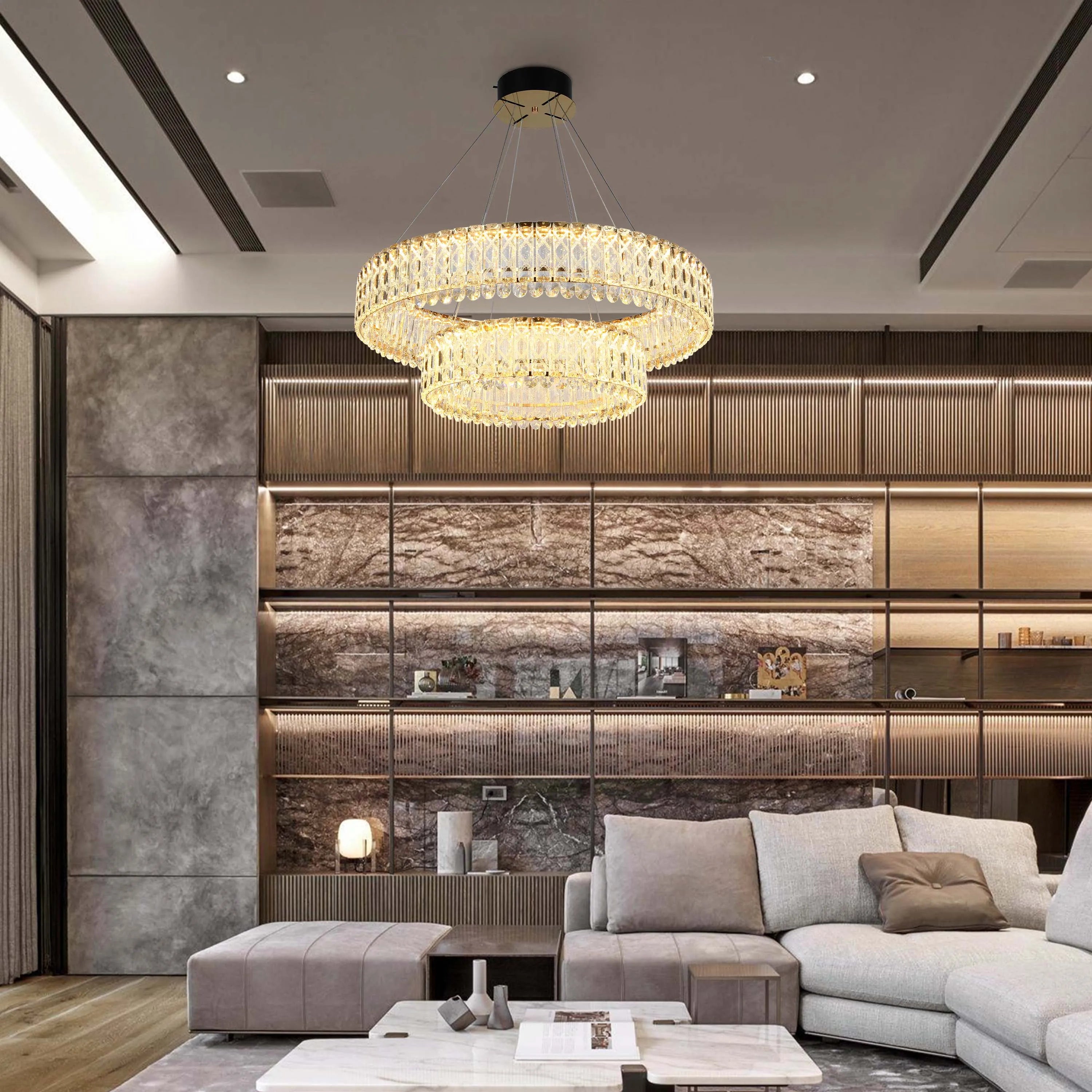 Two-tiered crystal chandelier casts a warm glow. Recessed lights accent the modern design, adding layers to the ambient lighting.