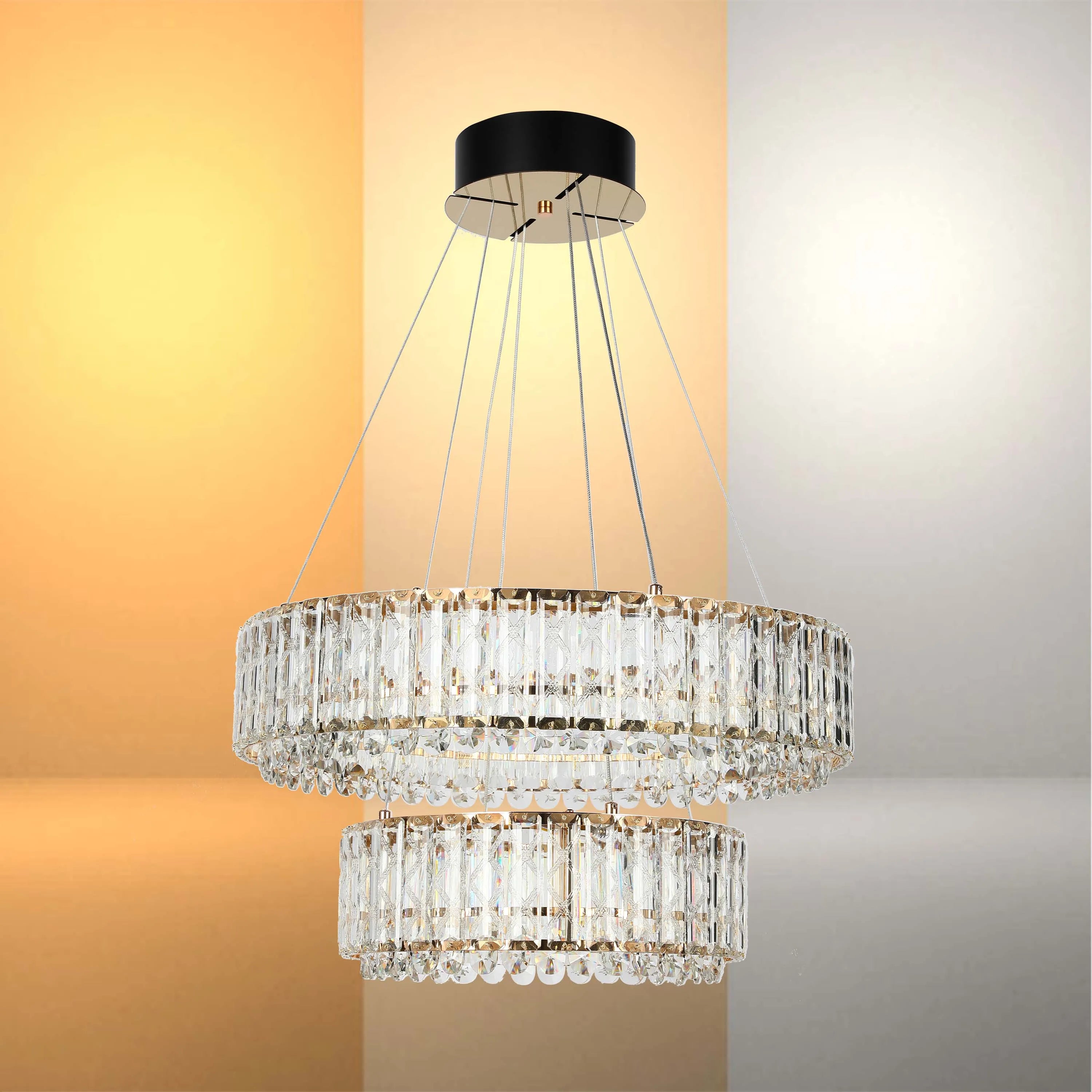 A two-tiered crystal chandelier hangs from a black ceiling rose, sparkling in the light. Modern and elegant lighting.