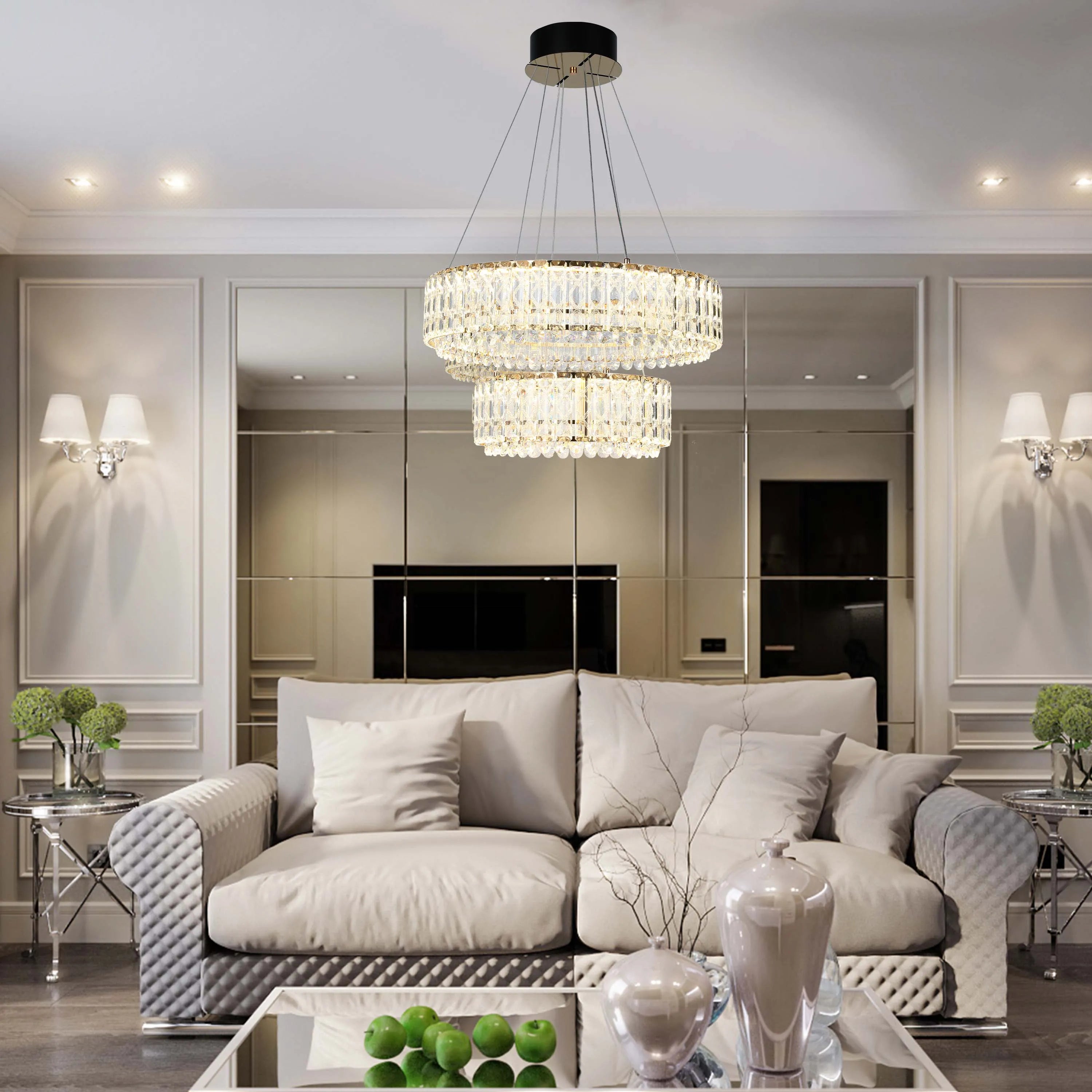 A modern living room featuring a two-tier crystal chandelier, wall lights, and recessed spotlights for a bright, elegant atmosphere.