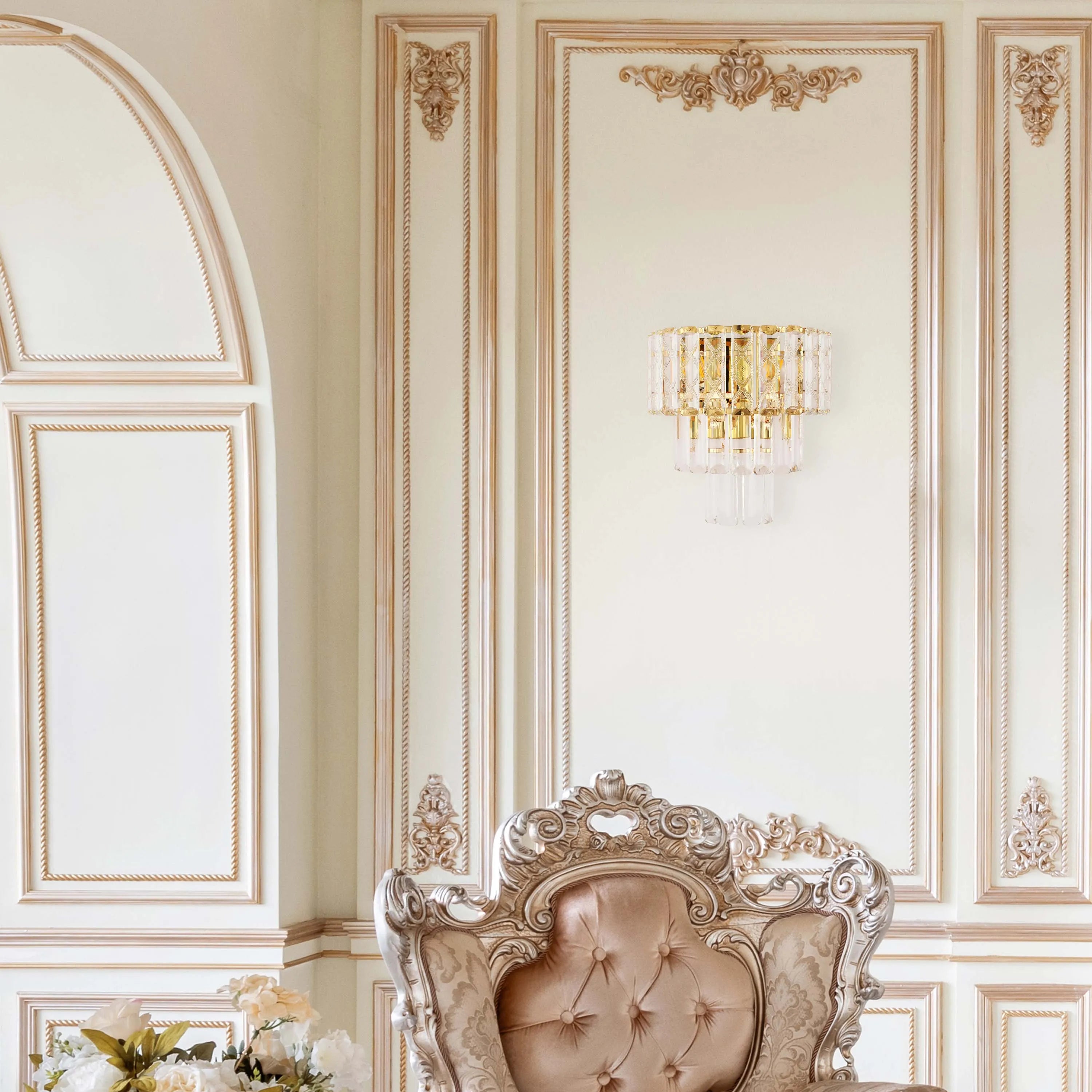 An opulent crystal wall light with a gold finish offers a soft, diffused glow in this lavishly decorated interior.