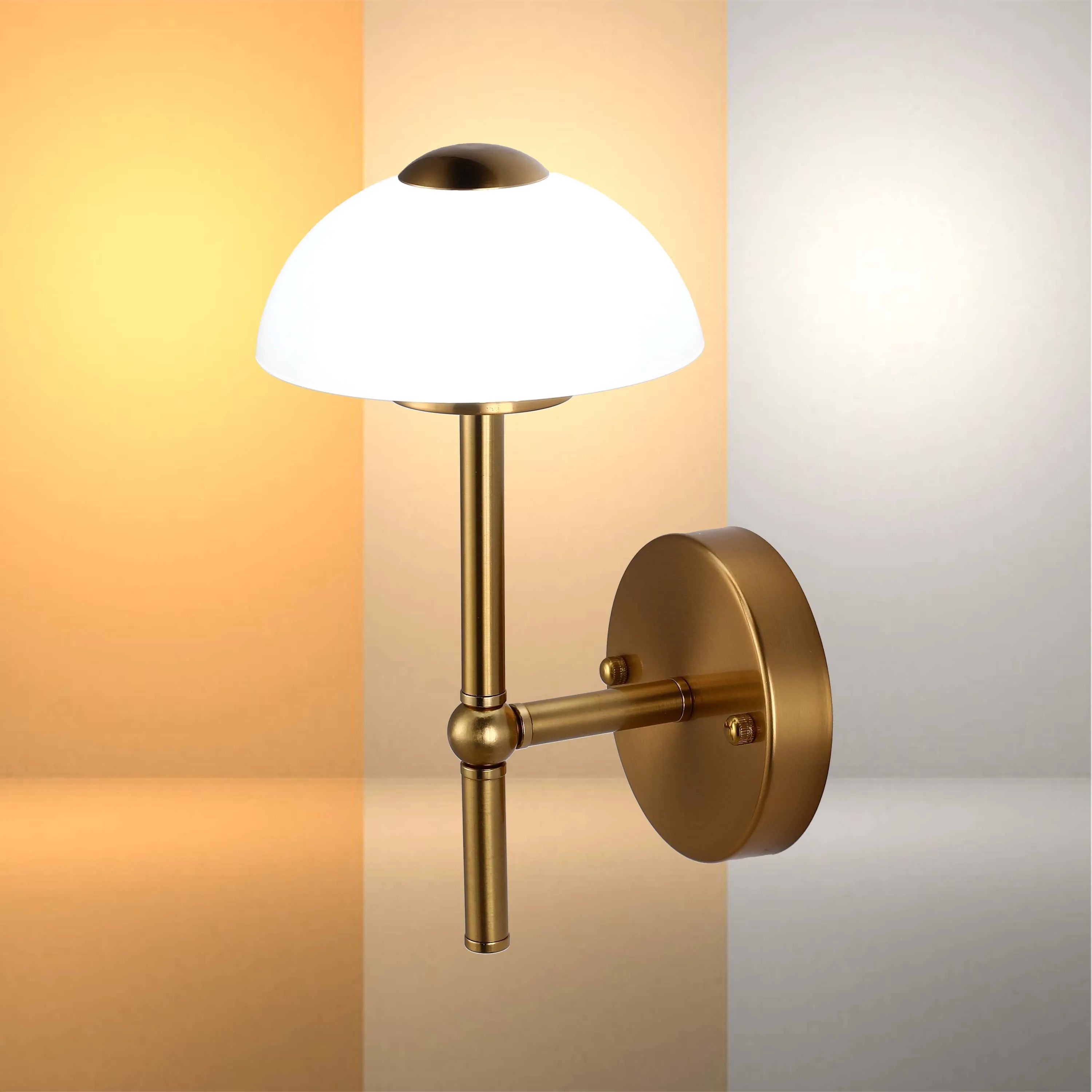 Stylish brass wall light with a white dome shade, providing a warm and inviting glow to any room.