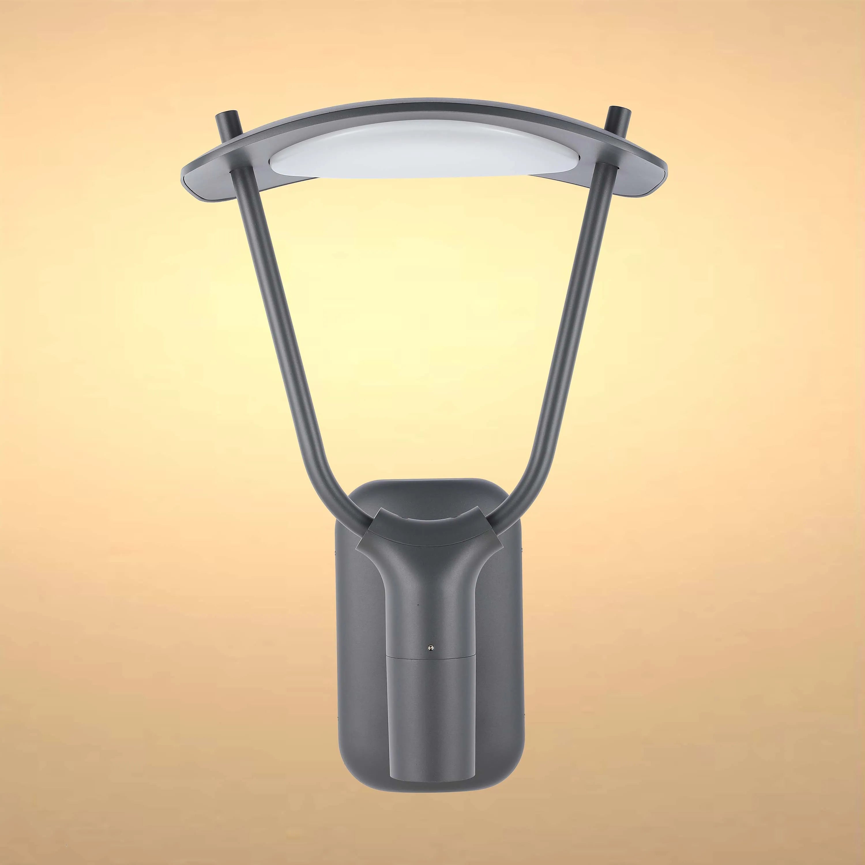 A contemporary outdoor LED wall light with a curved design and a grey finish against a warm yellow backdrop.