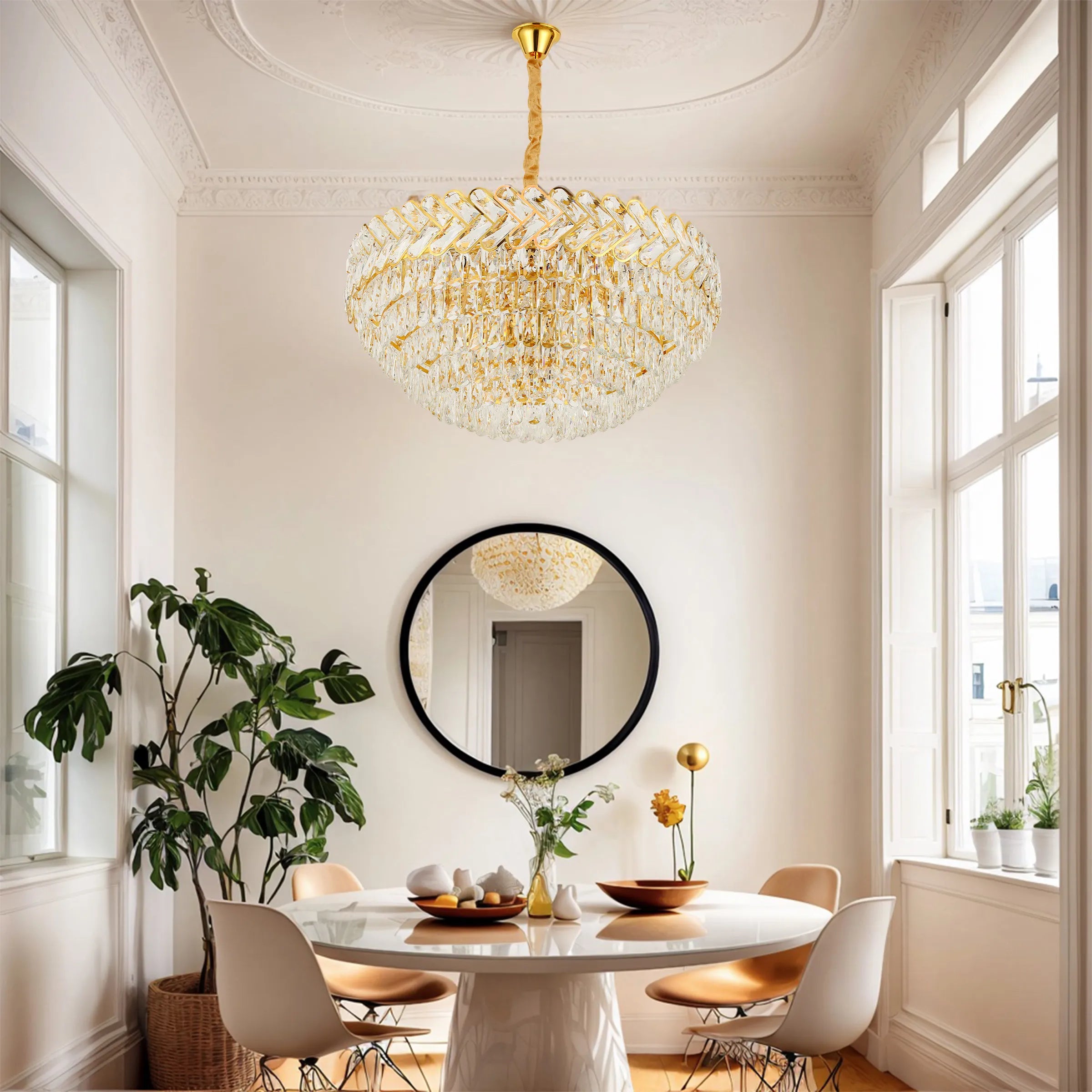 A dazzling, gold and crystal chandelier hangs above a bright dining room. Reflected in the mirror!