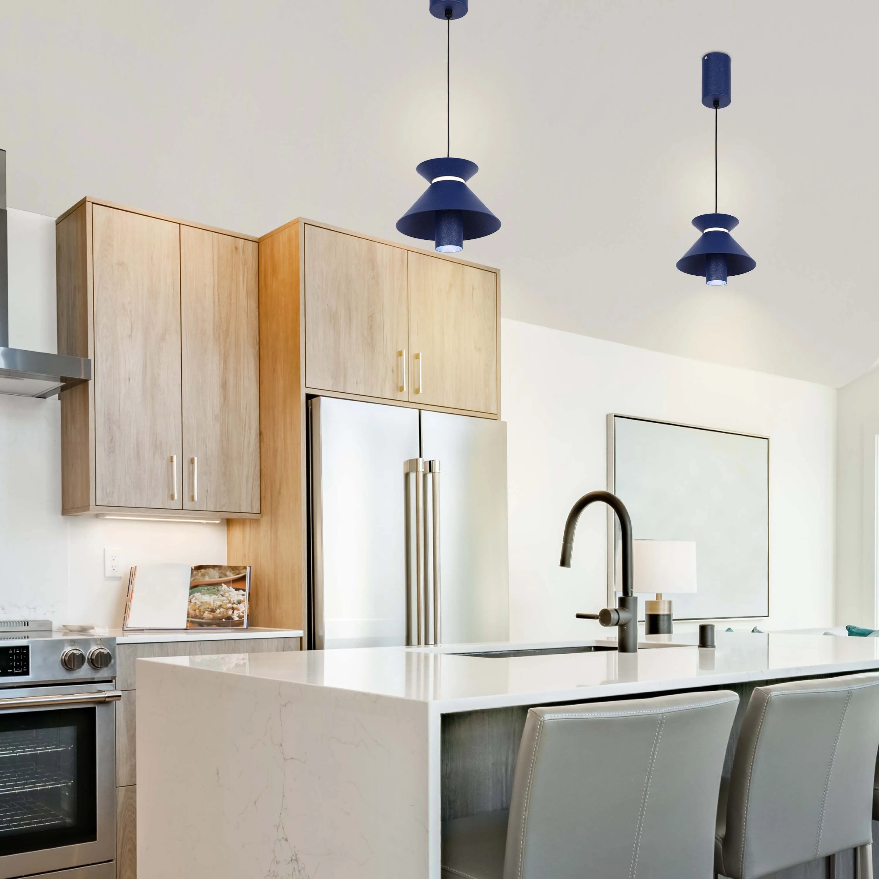 A modern kitchen is illuminated by two stylish, blue pendant lights that hang elegantly over the kitchen island.