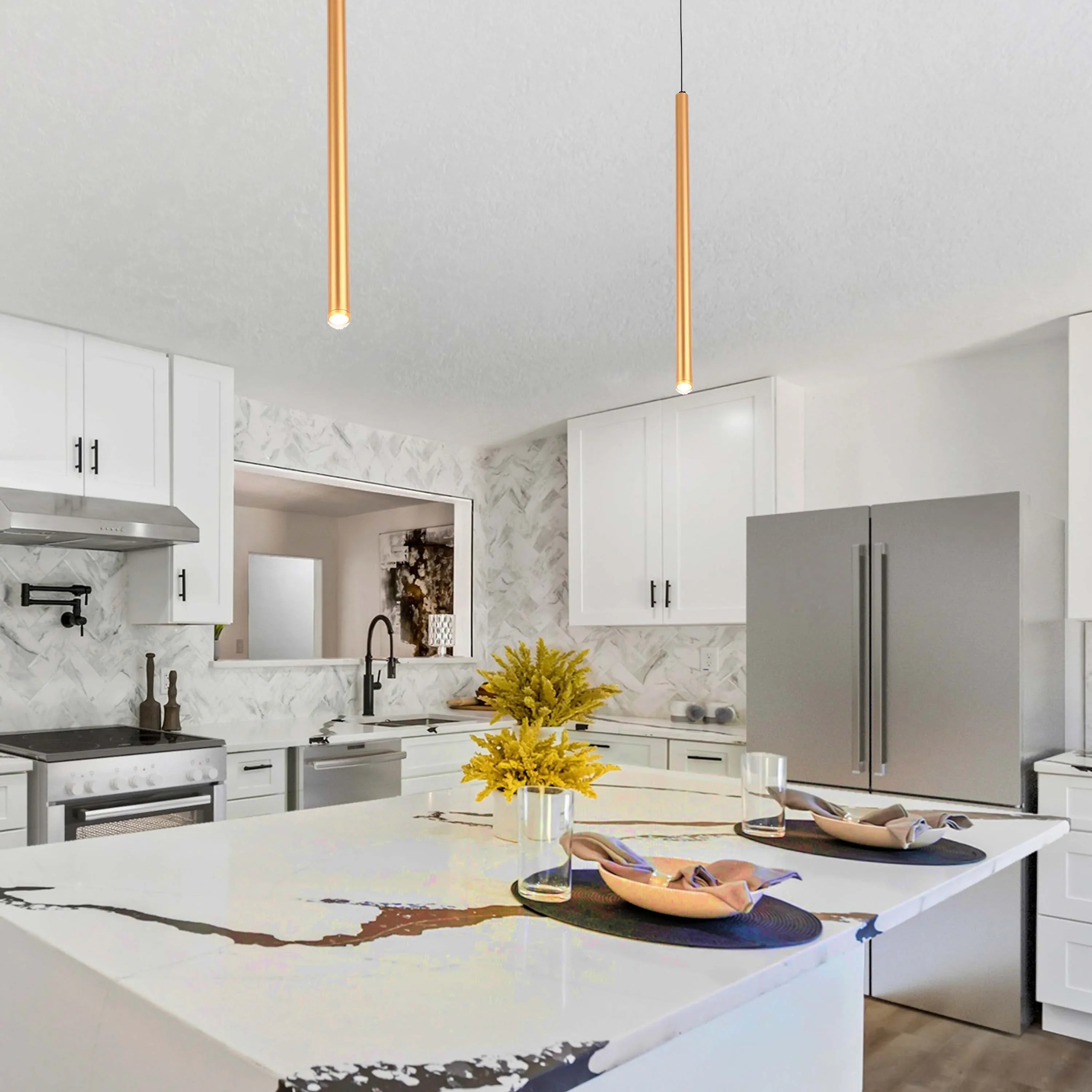 Two pendant lights hang above a kitchen island, illuminating the space with focused downlighting in a modern kitchen setting.