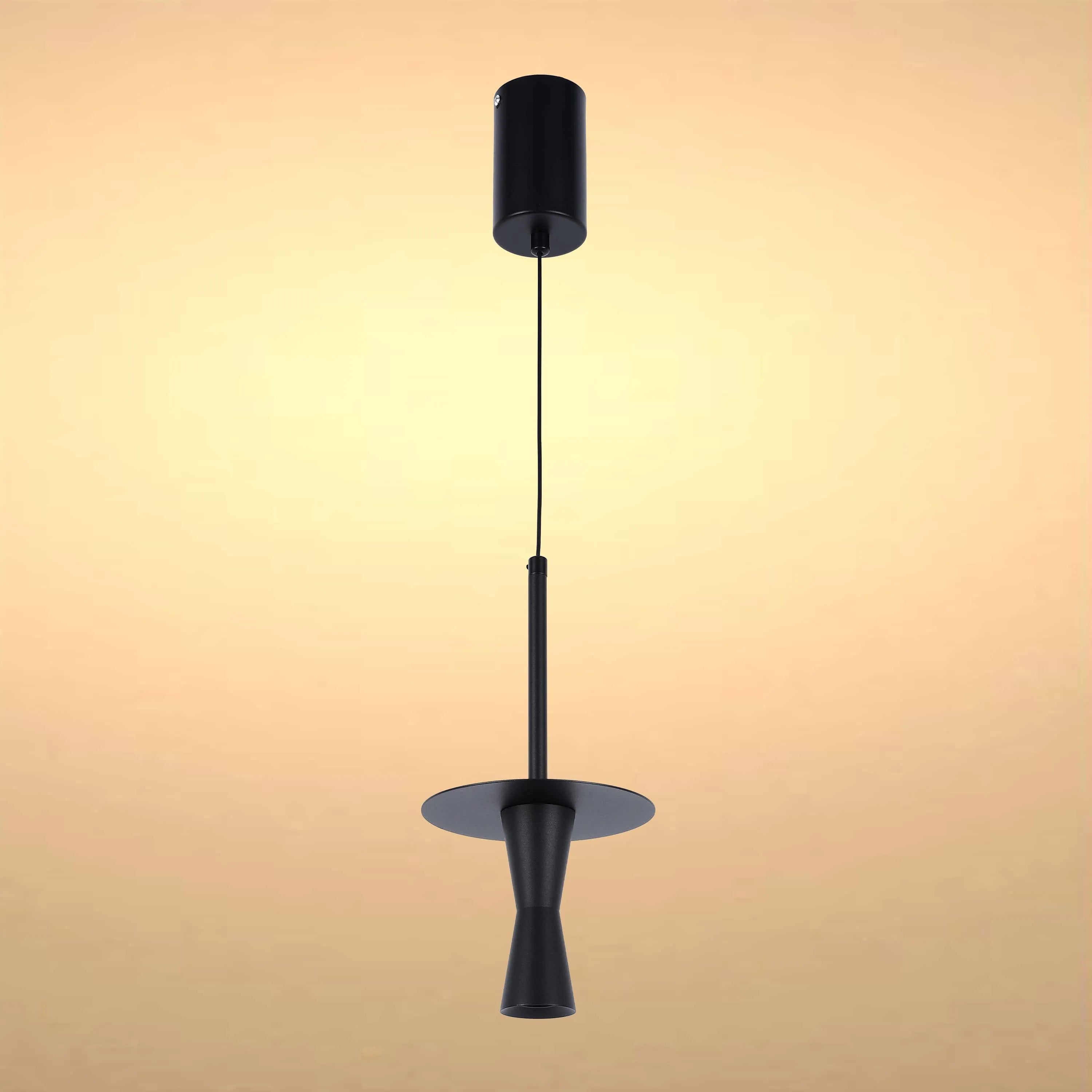 A stylish matte black pendant light hangs against a warm cream background, a striking addition to any modern interior.