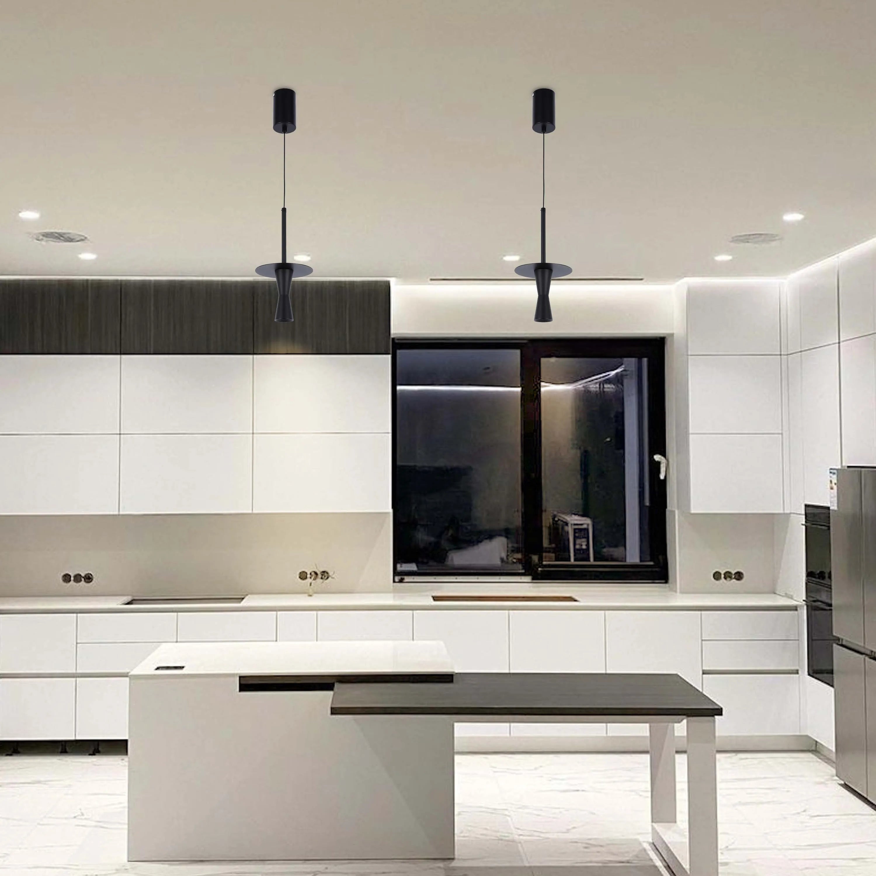 Contemporary kitchen with two black pendant lights over an island, creating a sleek and modern aesthetic.