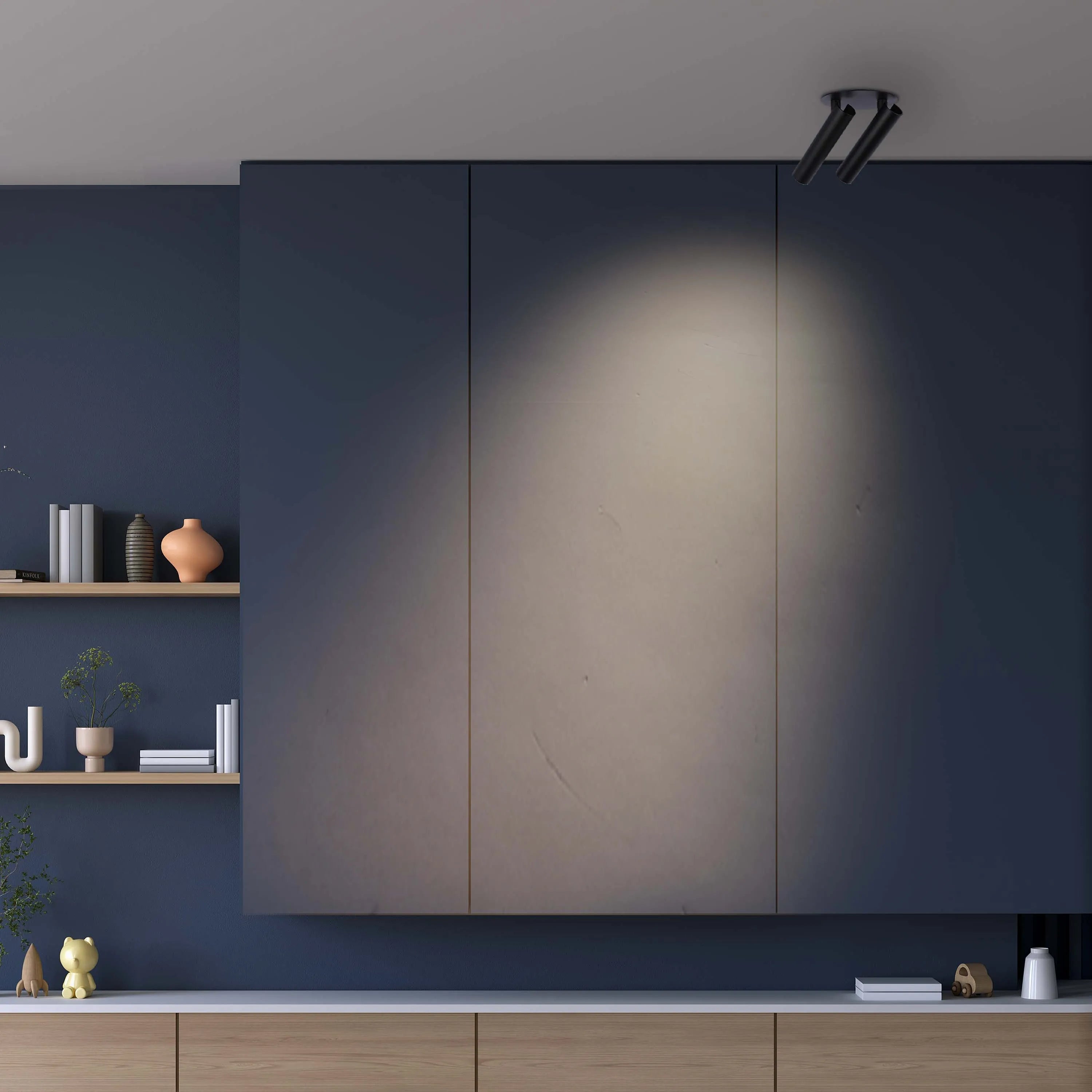 A directional spotlight illuminates the centre of three mounted cabinets, casting a warm glow against the navy backdrop.