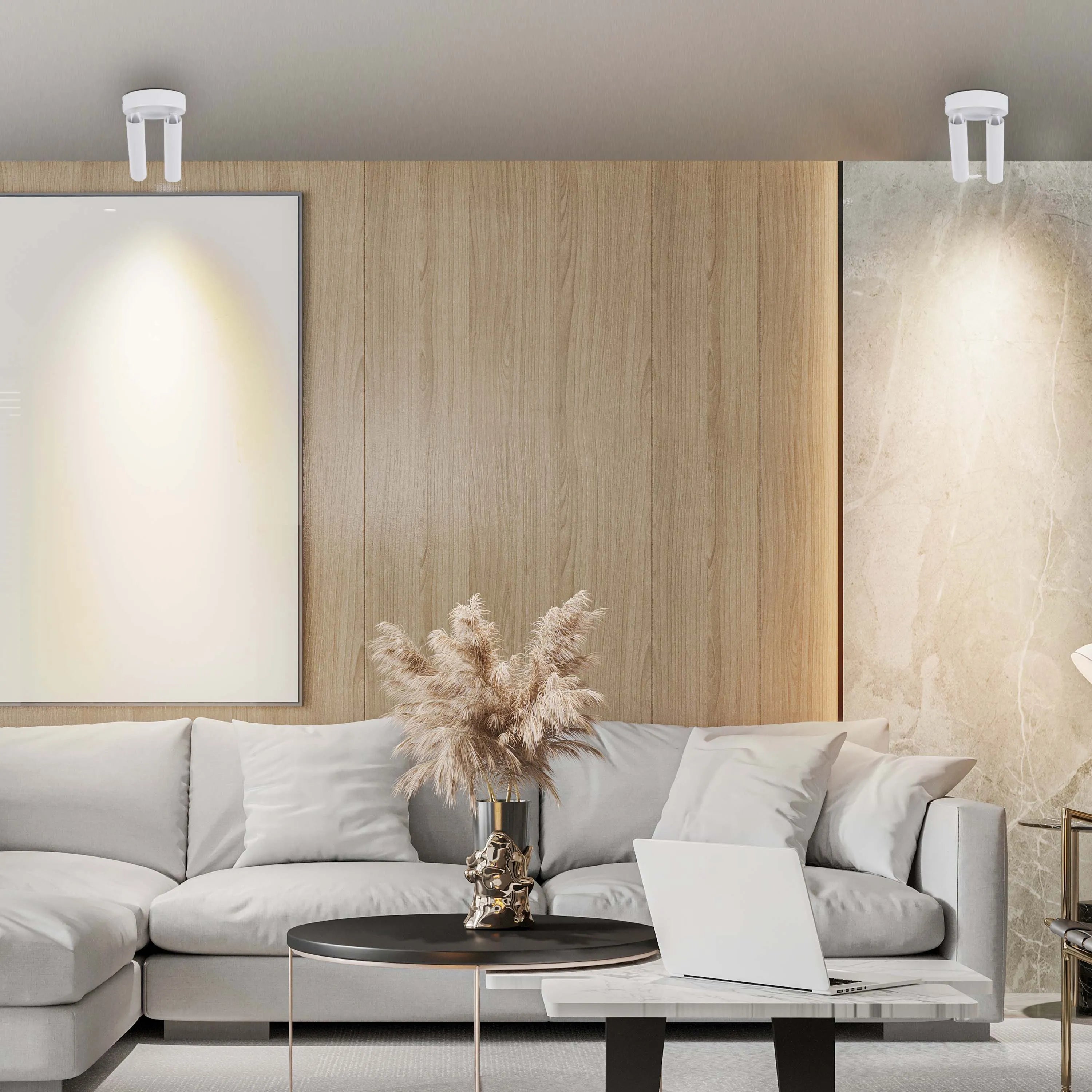 Contemporary room lighting features ceiling-mounted fixtures that are positioned to cast warm light on artwork and marble panelling.