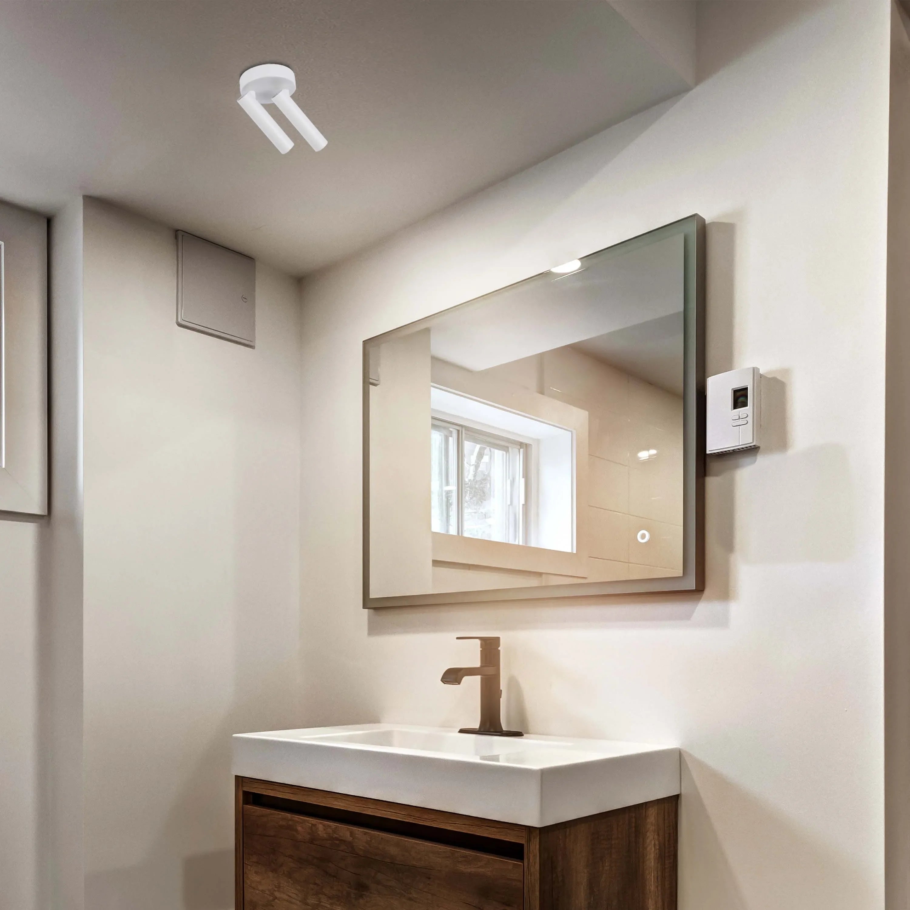 Contemporary bathroom lighting fixtures, including a sleek mirror light and adjustable spotlights, create a bright, stylish ambiance.