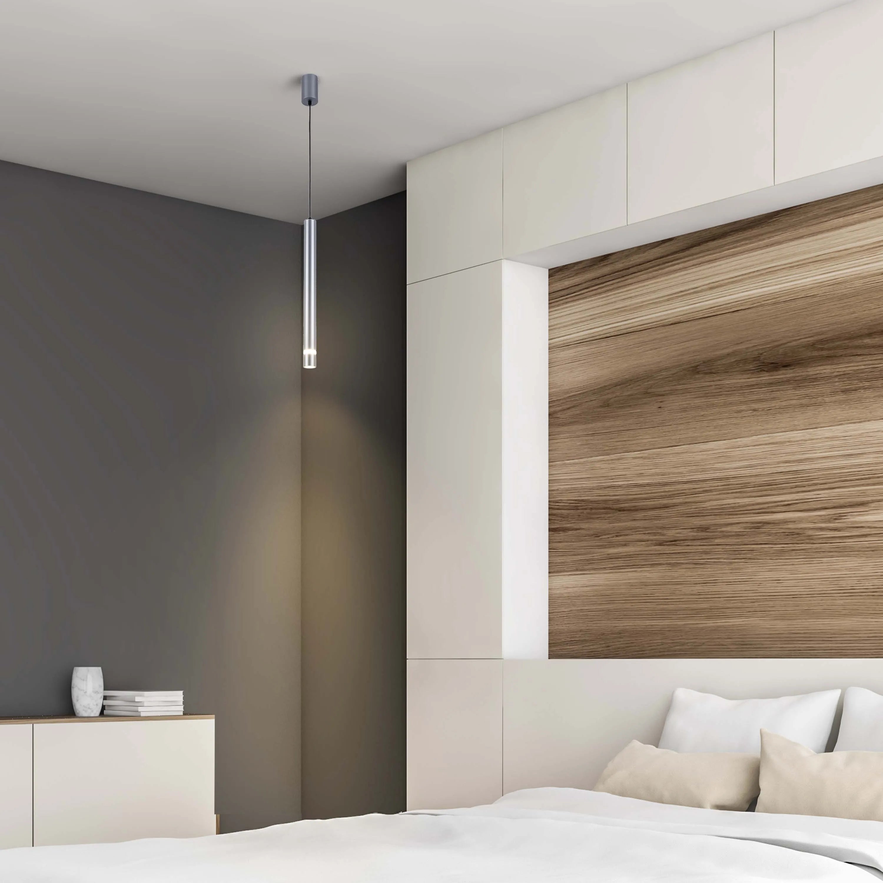 Minimalist cylinder pendant light, casting a warm glow in a modern bedroom setting.