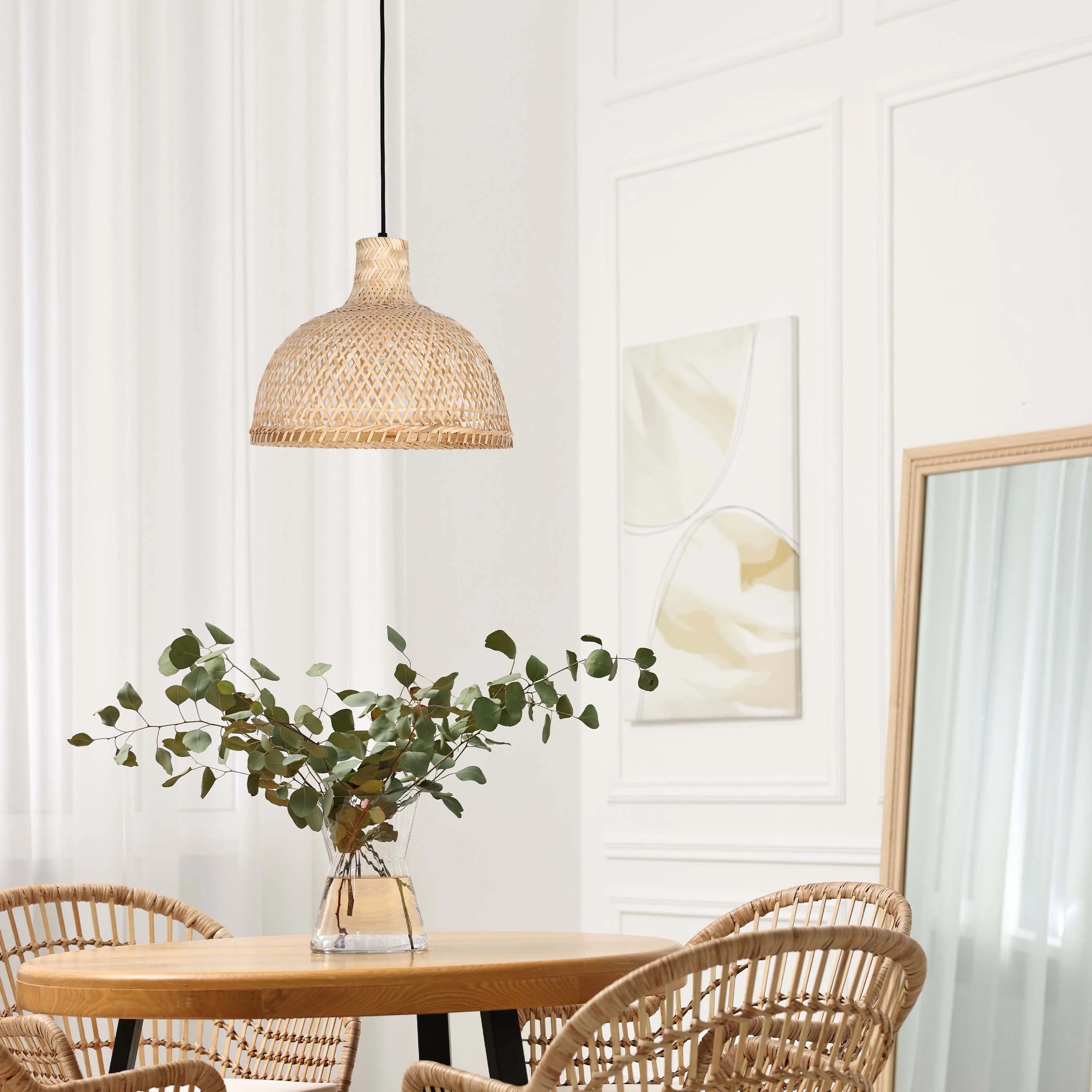 Wicker pendant light fixture illuminates the dining room, creating a warm and inviting atmosphere with its natural texture and soft glow.