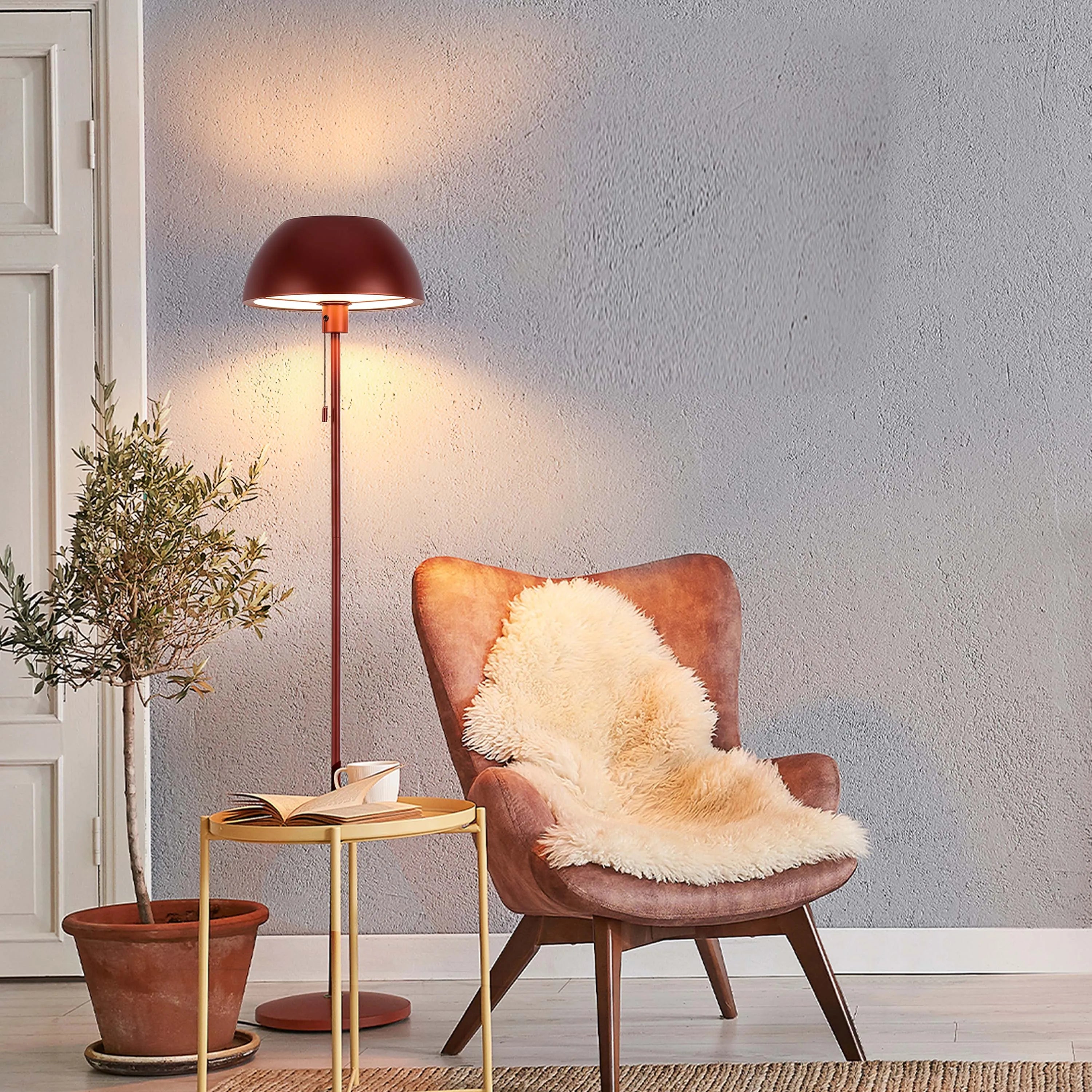 A cosy room setting is lit by a warm floor lamp. Soft, diffused light creates a welcoming and relaxing ambience.