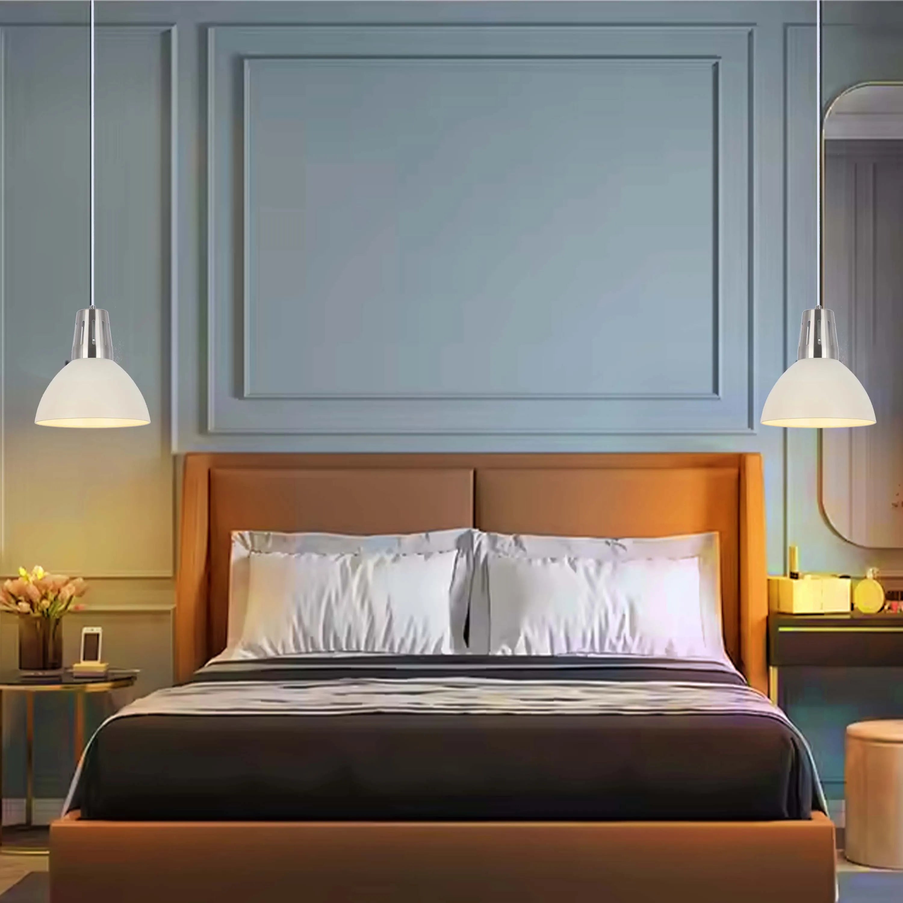 Bedroom with pendant lighting. Two dome-shaped lamps hang either side of the bed for a balanced and modern look.