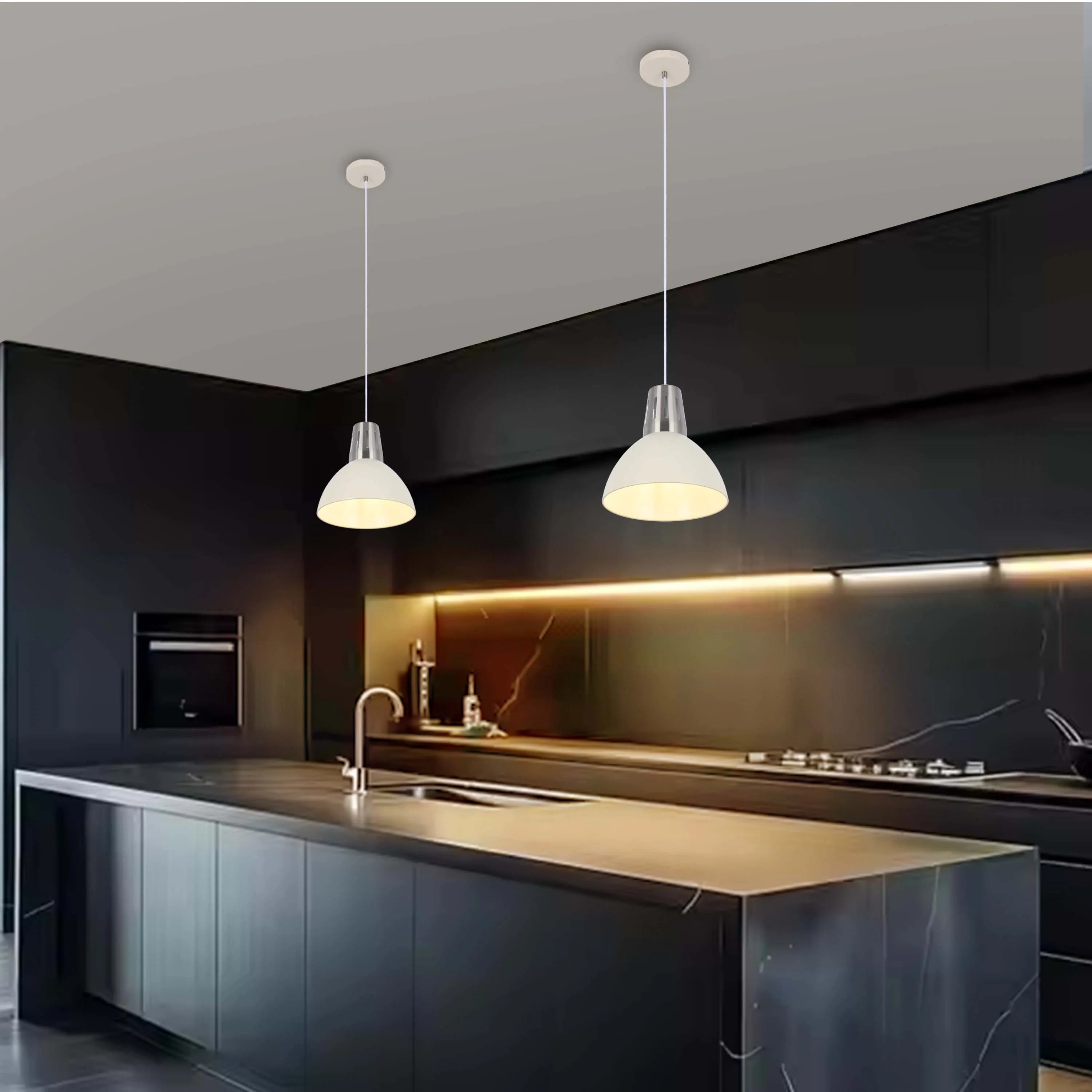 Two pendant lights illuminate a modern kitchen, casting a warm glow over the central island and sleek, dark cabinetry.
