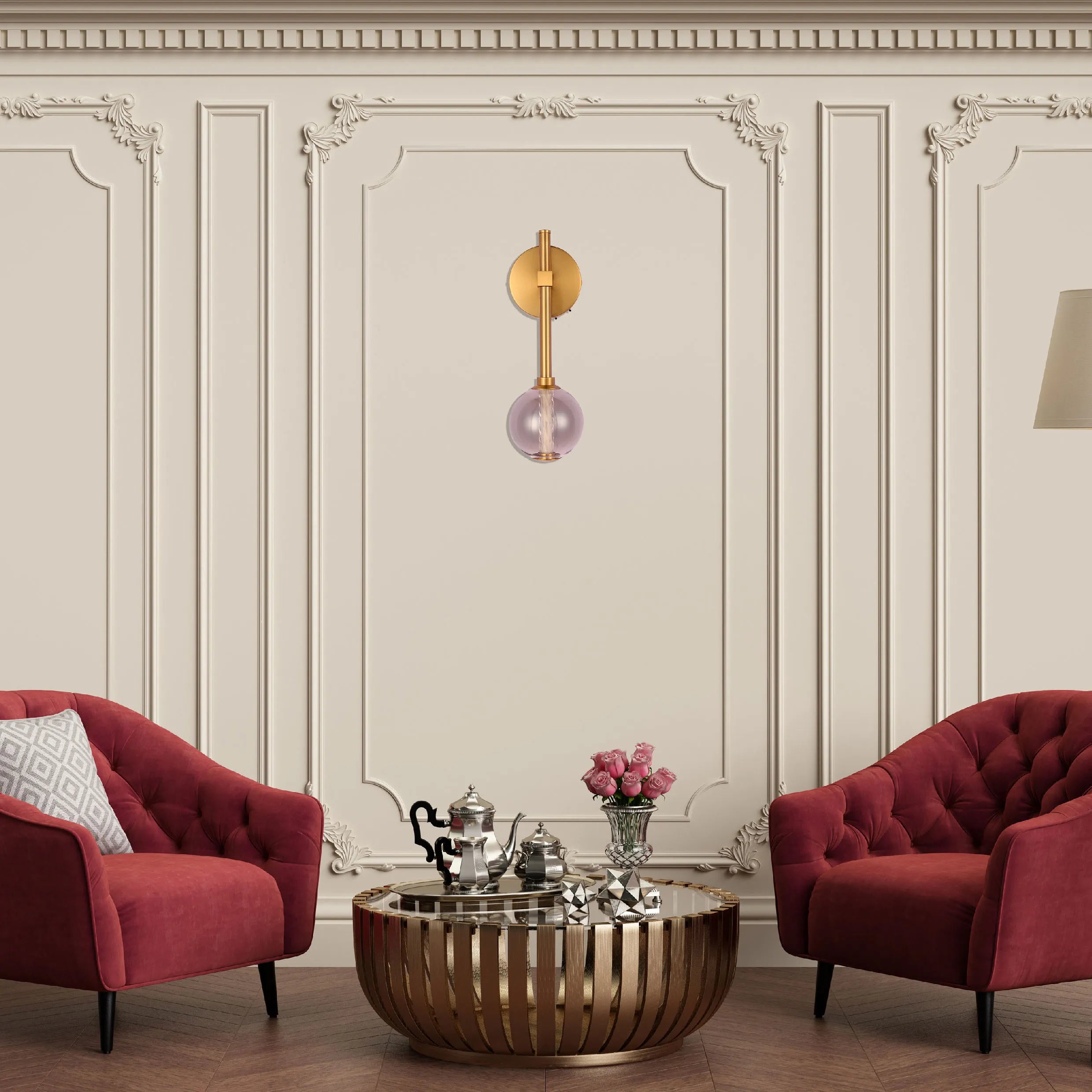 A decorative wall light featuring a gold fixture with a single, round glass shade in a soft pink hue.