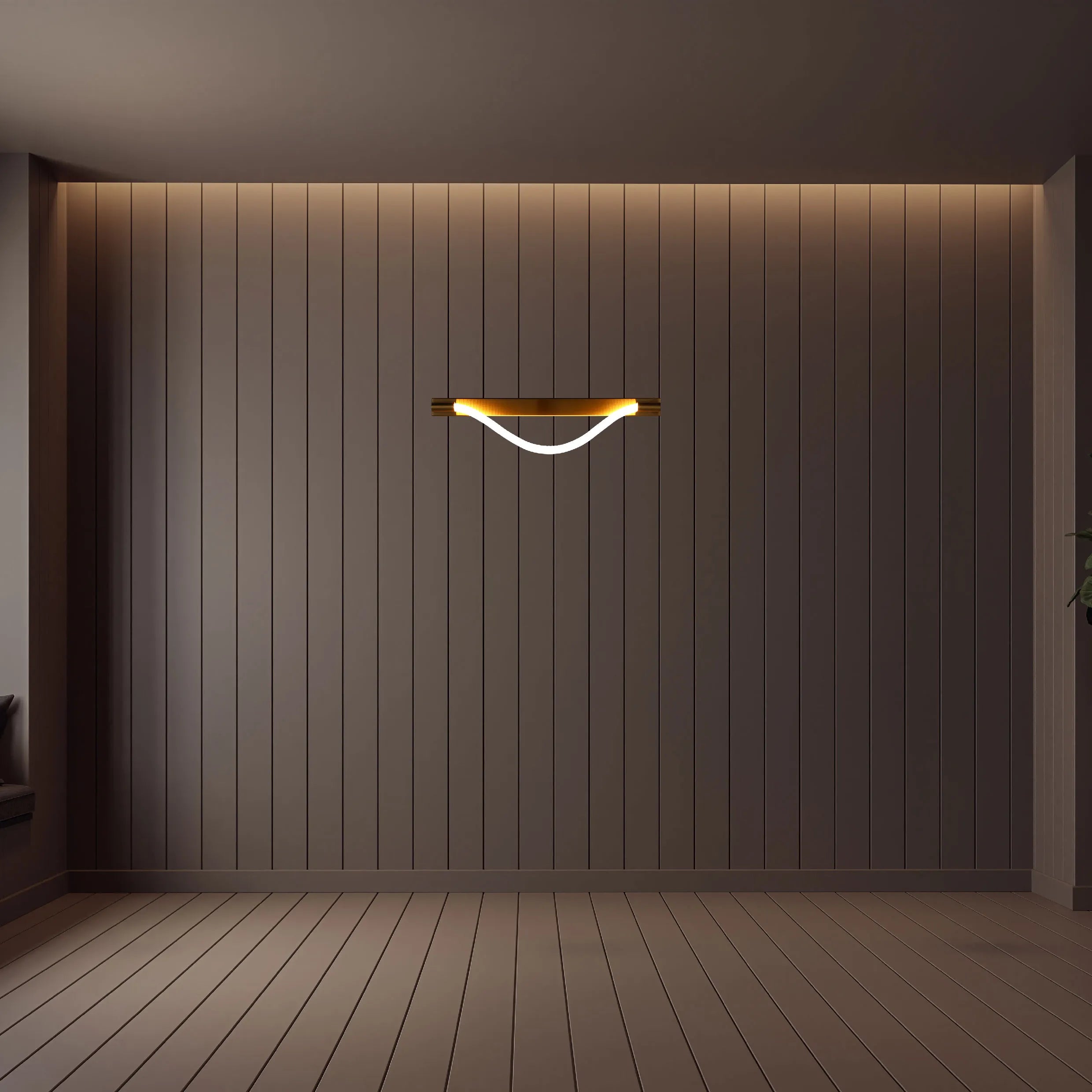 Modern, curved wall light with a brass fixture emitting a warm, ambient glow. Stylish interior lighting.