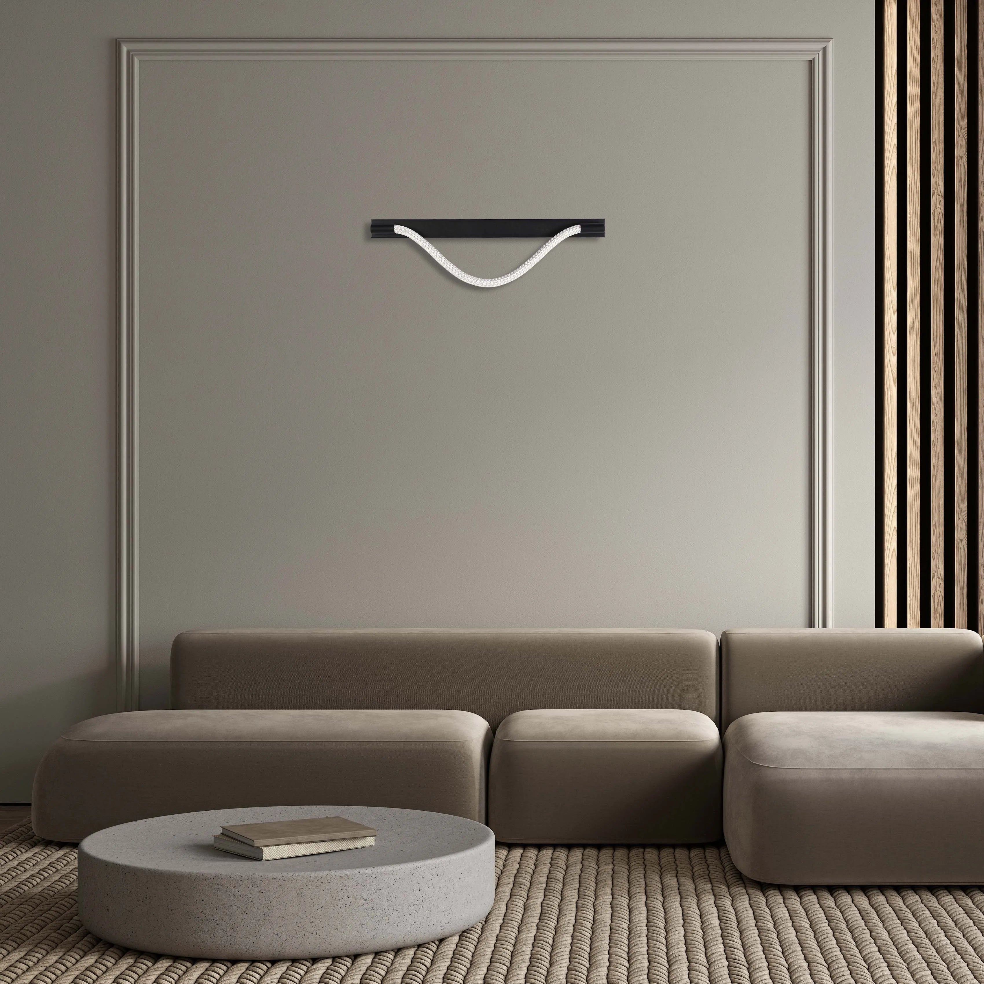 Modern wall light with a black shelf and a decorative rope-like light source, providing a soft, ambient glow.